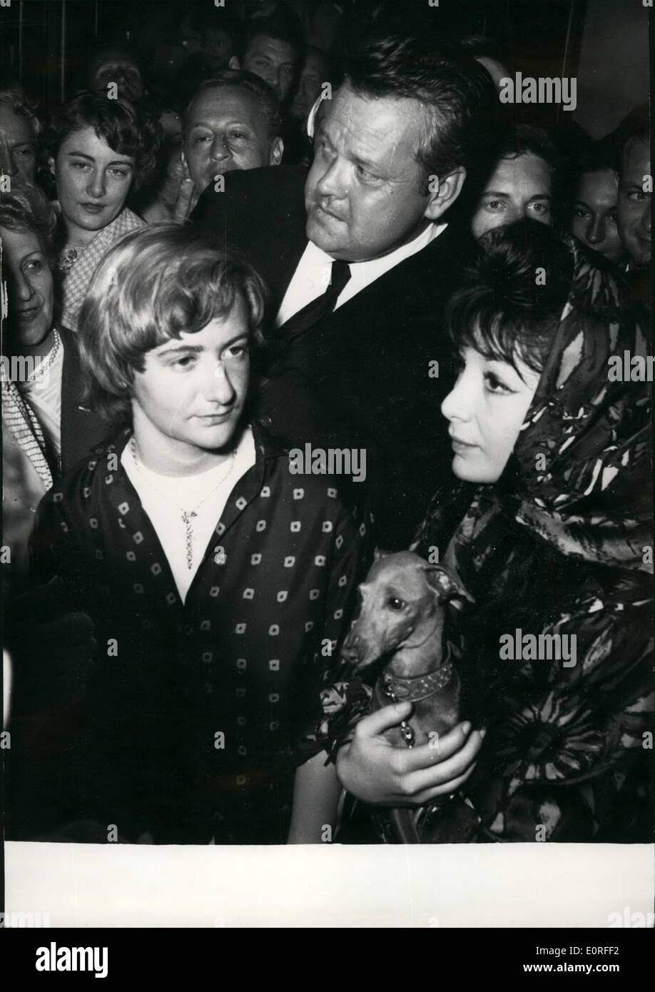 May 05, 1959 - Cannes film festival; Orson Welles photographed with Francoise Sagan and Juliette Greco holding a dog given to her by Daryl Zanuch. Orson Welles shown film ''Compulsion'' scored a great success. Francoise Sagan is said to be negotiating with Zanuck and Welles for a film based on one of her latest novels. Stock Photo