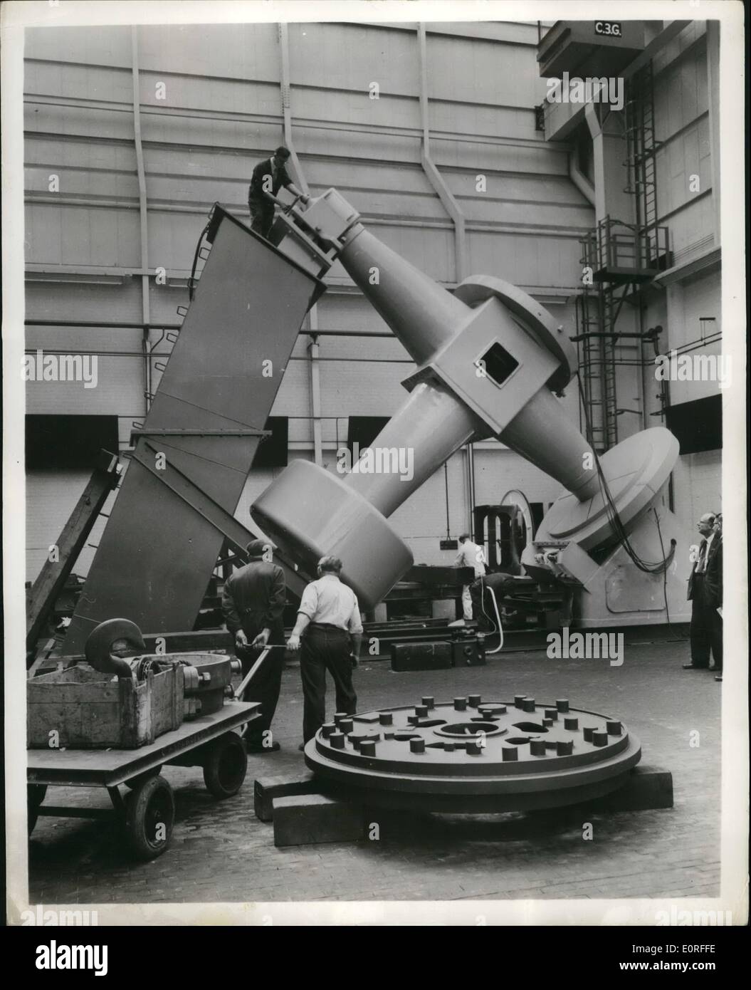 May 05, 1959 - International Eyes Telescopes on two sides of the globe will benefit from this work going on in a plant at Newcastle-on-Tyne, England. Picture Shows: Foreground (right): The wheel for a 74-inch telescope at Tokyo University, Japan. Background: Work on the mounting of a 75-inch telescope of the St. Michel Observatory. Basses Alpes, Province, France. Stock Photo