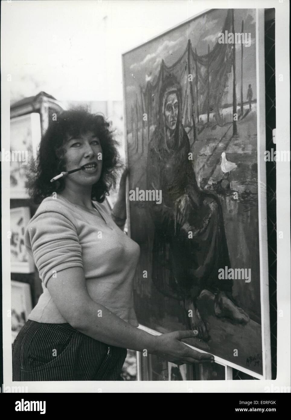 May 05, 1959 - The Annual Display of Paintings at Victoria Embankment gardens: For the 12th successive year the London Countly Council's annual display of paintings was held today at eh Victoria Embankment Gardens. Photo shows Anne Bulitis, of Swiss Cottage, complete with her long cigarette holder, displays her paintin called Meditation at the display at the Embankment Gardens this morning. Stock Photo