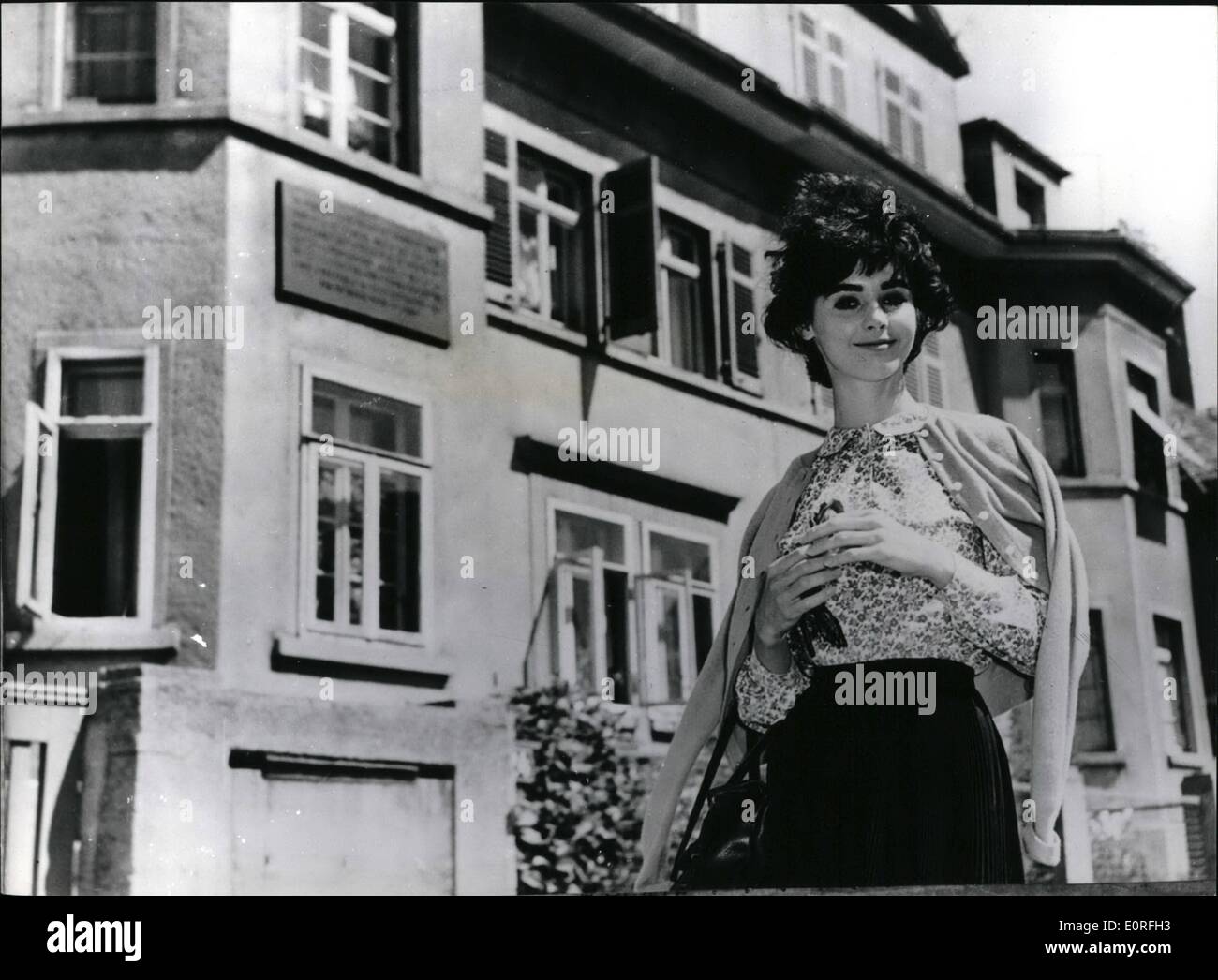May 05, 1959 - Star of ''The Diary of Anne Frank'' film visits Anne's birth place. The young American actress Millie Perkins who played the title role in the film ''The Diary of Anne Frank'' who is on European tour before the world premiere of the film in London next month paid a visit to the house in Gangahfer street, Farnkfurt, Germany, where Anne Frank was born. Photo shows Millie Perkins pictured in front of the Anne Franks birthplace in Frankfurt. Stock Photo