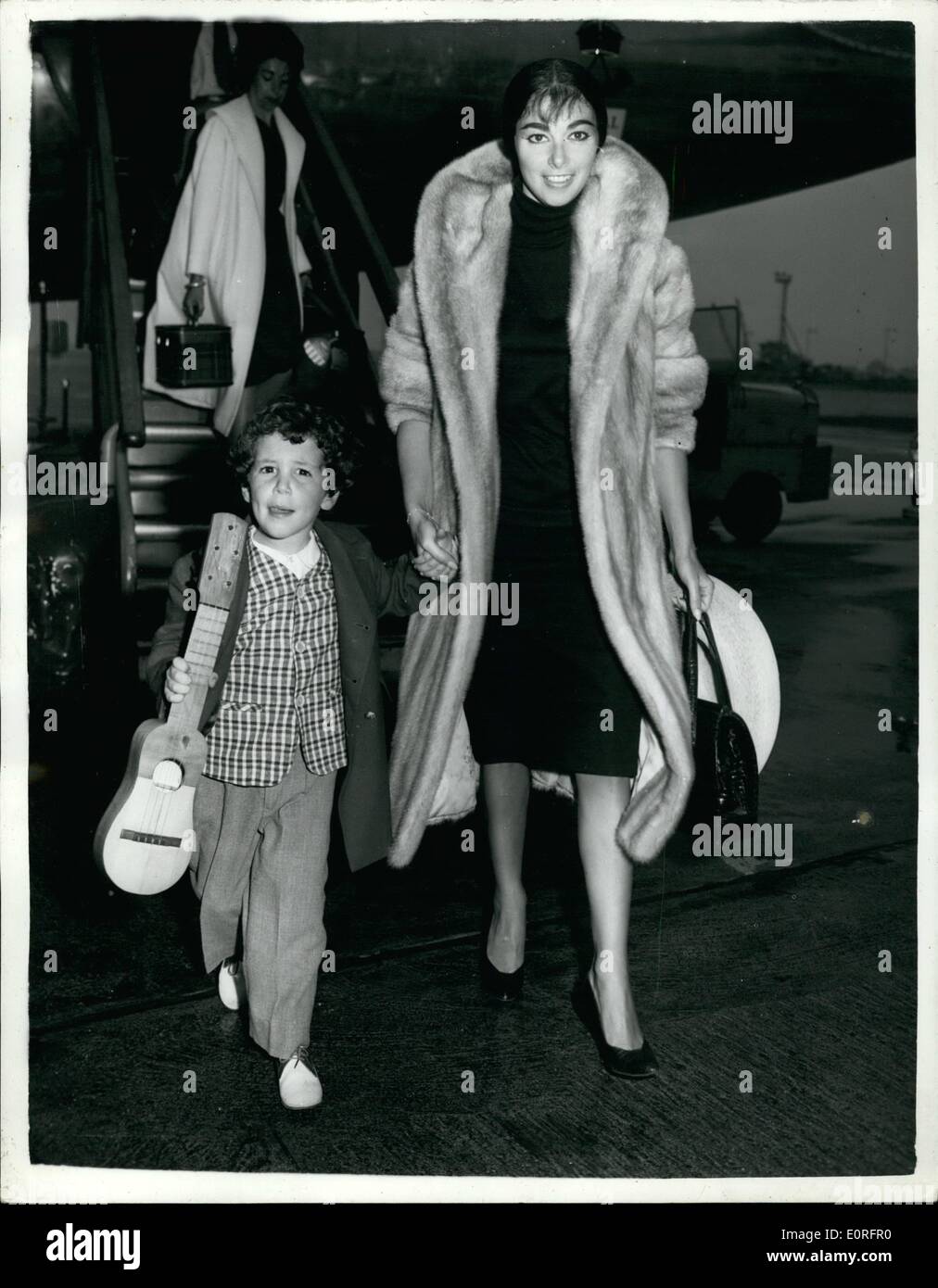 May 05, 1959 - Pier Angeli and her three-year-old son fly into London Airport: Two angry film stars - Eva Bartok and Pier Angeli - stranded with their children yesterday at Las Palmas Airport, eventually got away from there by air today. Eva and Pier who had been filming in ''S.O.S. Pacific in the Canary Islands, should have flown back to England yesterday with the rest of his film unit. But Airline officials told them that they could not take their children with them because of a ruling that only passengers who had flown out by chartered airplane could fly back by it Stock Photo