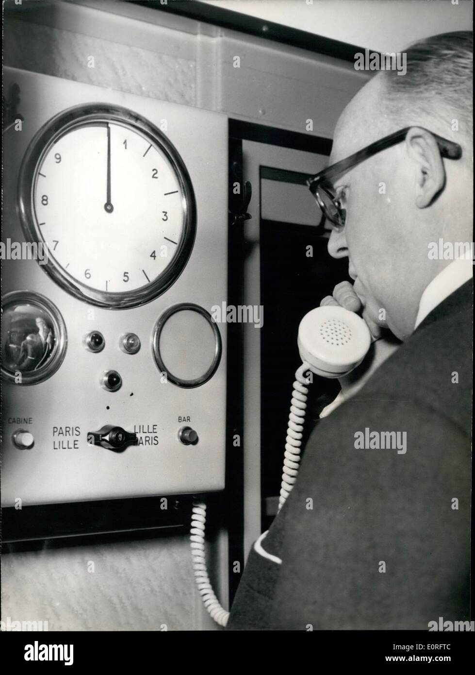 May 05, 1959 - A Telephone in the New Trains Paris Lille: The National French Railways Society Presented to day one of the New trains to be put in service on the line Paris Lille. the Waggons are made in Rustless steel. Each train has a Bar Waggon with a sound proof telephone booth. Photo Shows A Traveller talking on the telephone in the Bar Waggon. Stock Photo