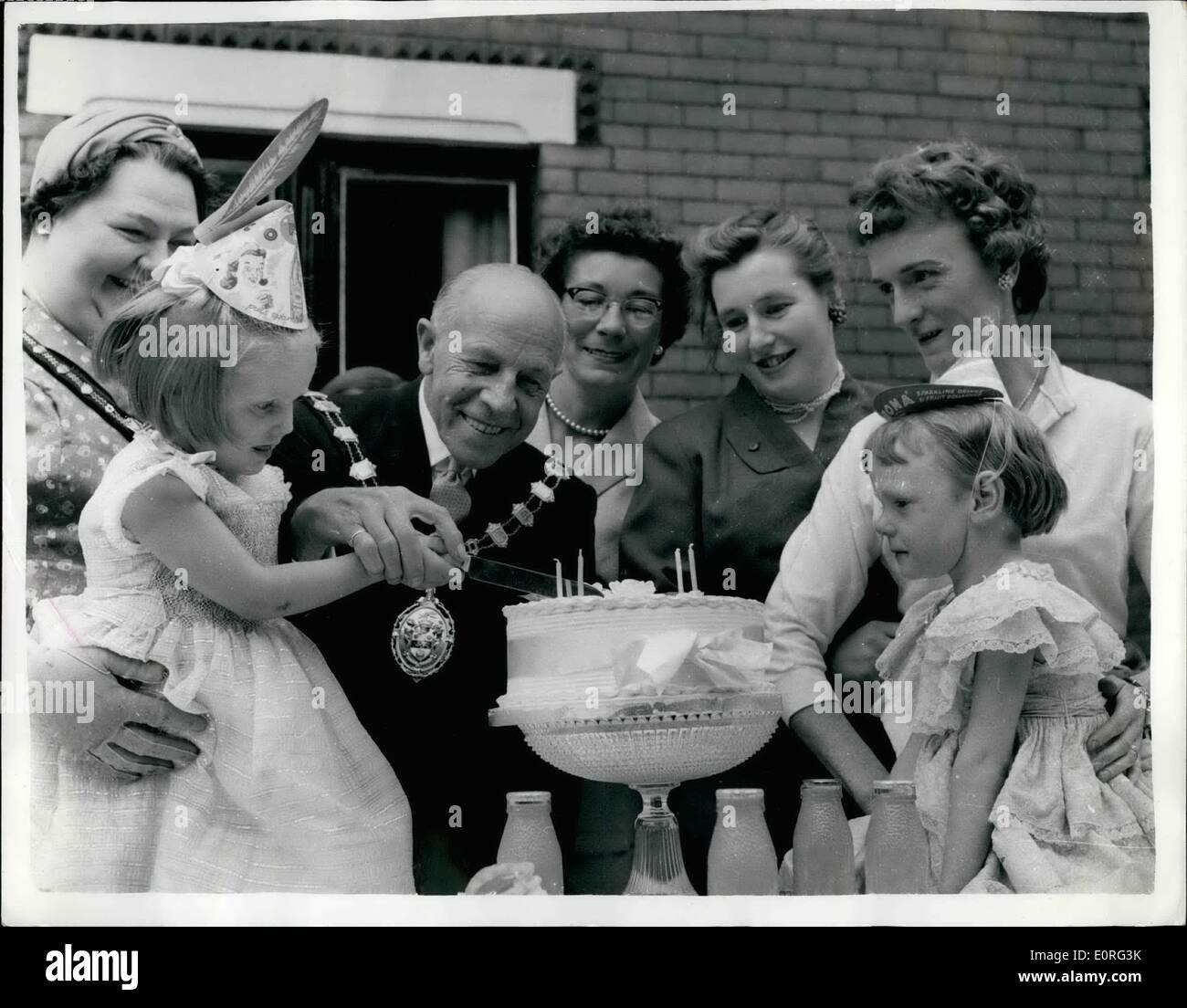 Aug. 08, 1959 - Little Ann's Rescue Party: There were four V.I.P. guests at Ann Culverwell's fourth birthday party - but for them there would not have been a party. Seven weeks ago Ann fell into a cannal near her home in Raleigh-street, Stretford, near Manchester. Her four-year-old friend, Madeline Murphy, raced 100 yards to tell her mother, a neighbour of the Culverwells., Then, with two other neighbours holding on to her legs, Mrs. Murphy hung head down in the water and fished out Ann. Little Ann's mother was a grateful that she organised a street birthday party Stock Photo