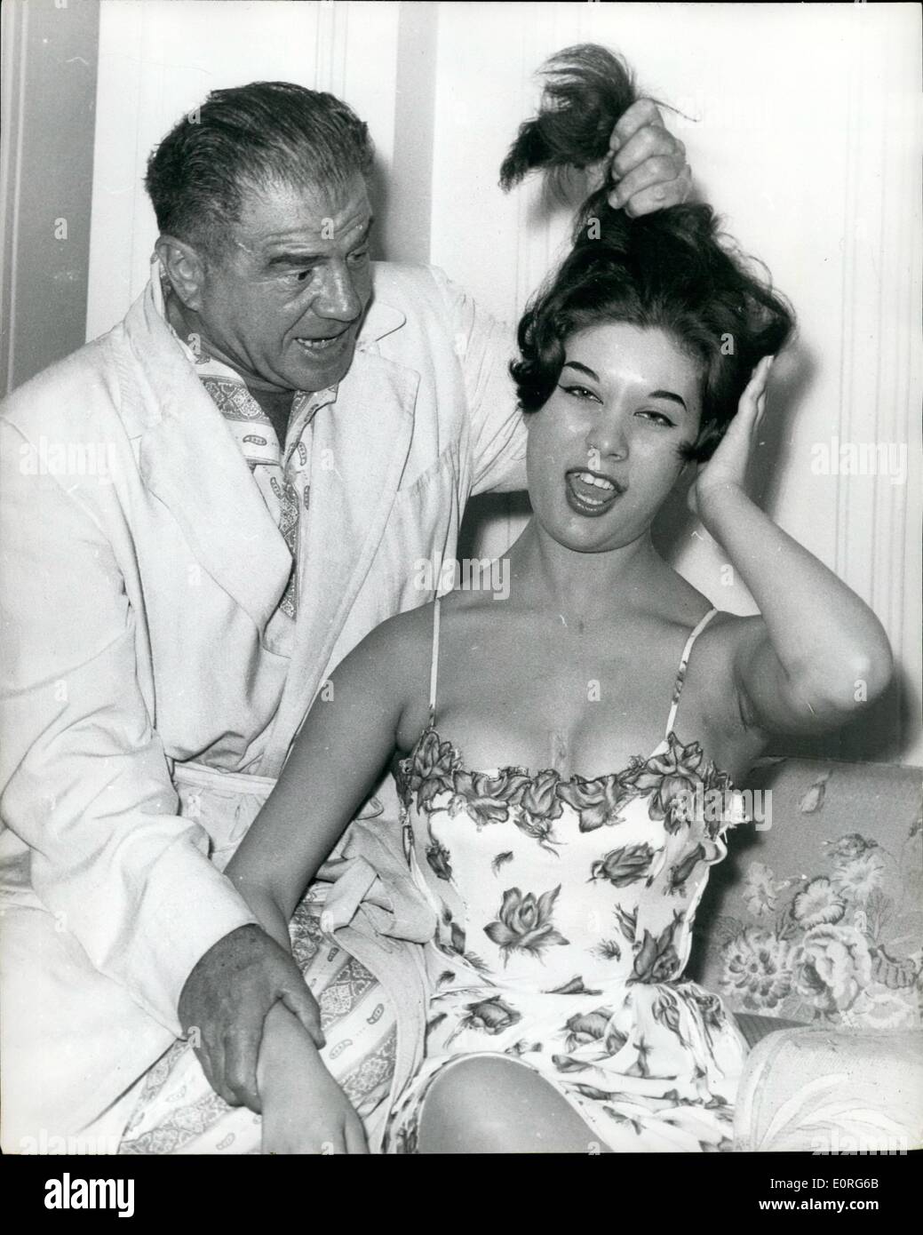 Aug. 08, 1959 - Lionel Stander in London: Photo shows Ex-American actor and TV producer Lionel Stander, who has appeared in more than 100 films, pictured in his suite at the Savoy Hotel yesterday, pulling the hair of Wendy Withers, a model for whom he prophesies a great future. Stander is on his way to Ireland where he will make picture. Stock Photo