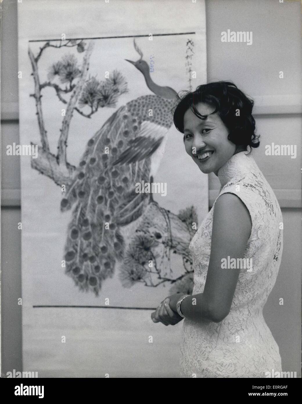 Jul. 00, 1959 - Chinese Air Hostess Holds Exhibition Of Her Painting In London: An exhibition of paintings by B.O.A.C. air hostess Miss Theresa Wai Ching Kwa from Hong Kong-opened this morning at the Commonwealth Institute, South Kensington. The work of Theresa as an artist is highly regarded in Hong Kong. She employs traditional Chinese techniques and among her subjects are bamboo, chrysanthemums; pine trees, birds and fish. Photo shows. Miss Theresa Wai Ching Kwa with some of her paintings at the exhibition this morning. Stock Photo