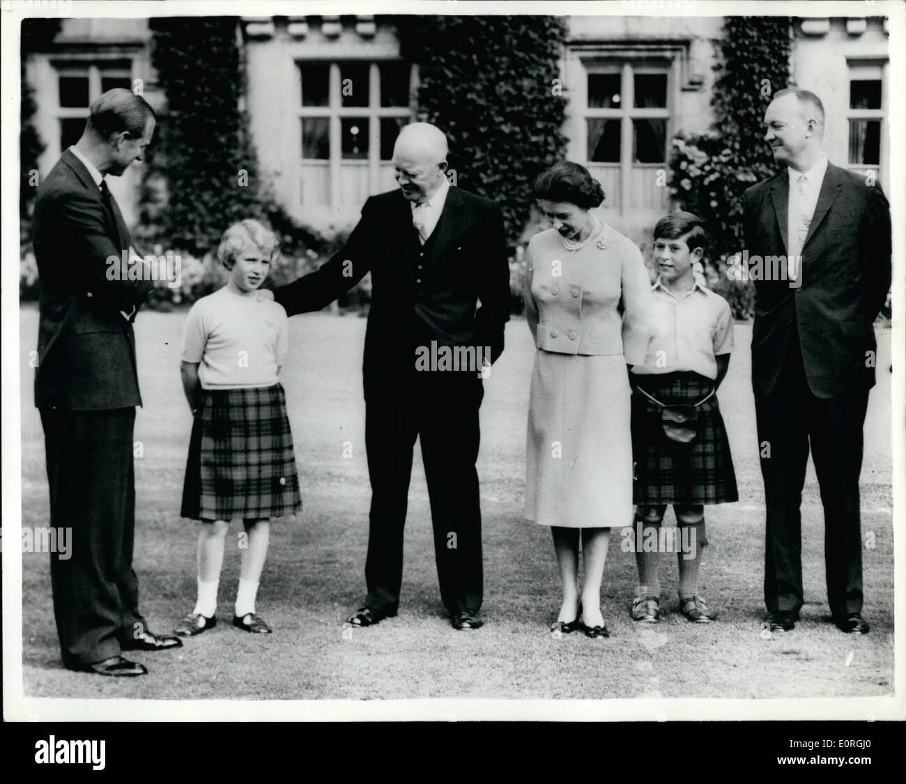 Aug. 08, 1959 - President Eisenhower meets the Royal Family at Balmoral Castle.: Prisdent Eisenhower spent a happy ten minutes chatting and being photographed with the Royal Family on the lawns at Balmorel Castle today before leaving on his trip south to Chequers where he will spend the week-end having talks with Mr. Macmillan. Photo shows President Eisenhower puts his hand on Princess Anne's shoulders as he poses for photographs with the Queen, Prince Philip, the Prince of Wales and on right is Major John Eisenhower, the President's son. Stock Photo