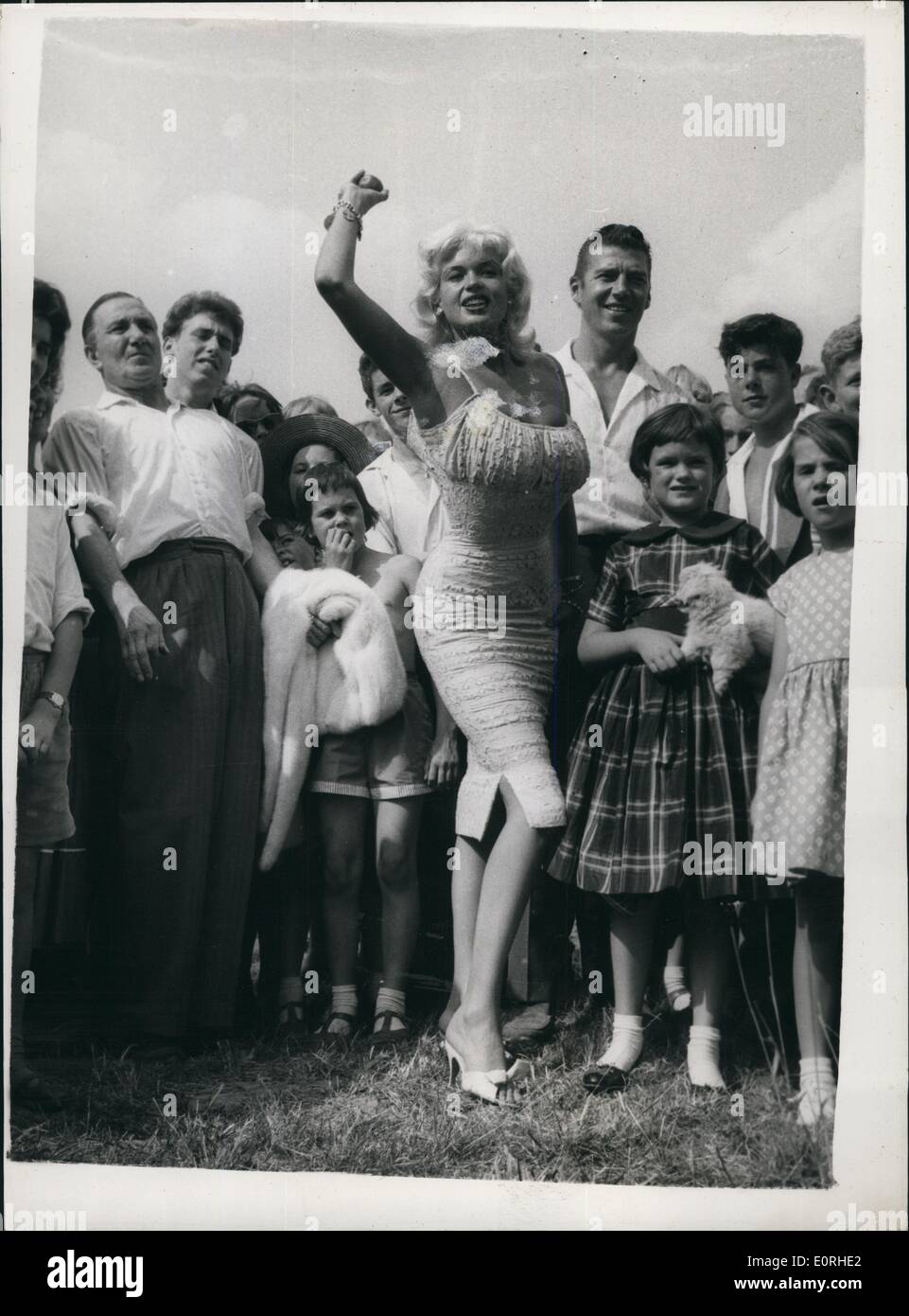 Aug. 08, 1959 - Jayne Mansfield attends garden Fete: American film-star Jayne Mansfield with her husband Micky Hargitay this afternoon attended a garden fete at Angering-on-Bea in Sussex. The fete was to help raise funds for the nearby St. Pridgets - the home for the incurably sick, set up by group captain Leonard Cheshire V.C. Photo shows Jayne Mansfield trys her hand at coconut shy, one of the many side shows at the fete. Stock Photo