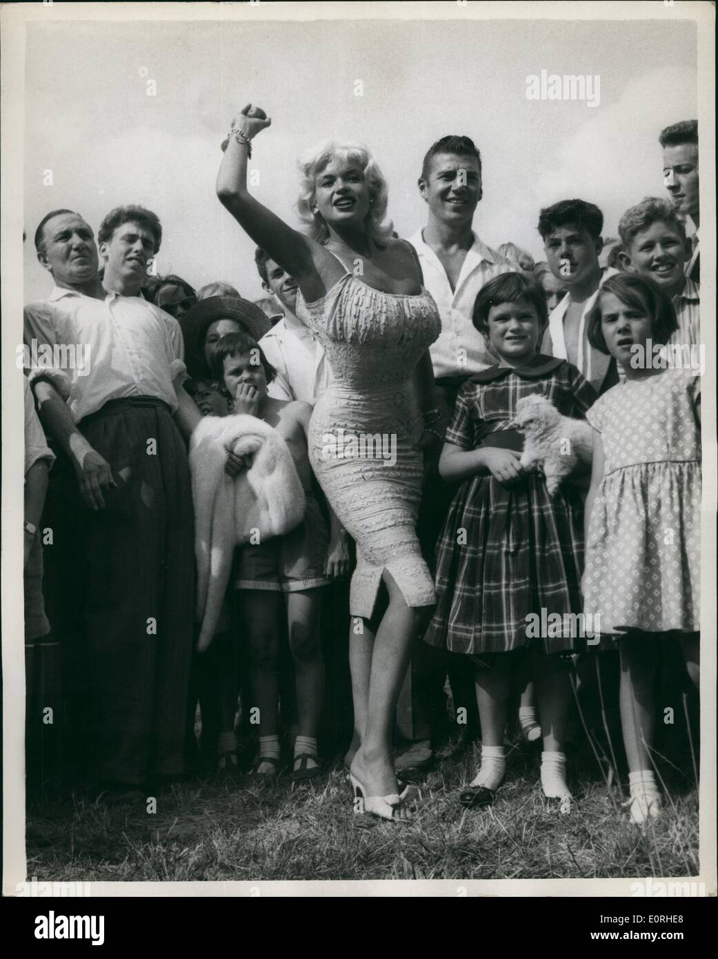 Aug. 08, 1959 - Jayne Mansfield Attends Garden Fete: American film-star Jayne Mansfield with her husband Micky Hargitay this afternoon attended a garden fete at Angmering-onsea in Sussex.The fete was to help raise funds for the nearby St. Bridget's - the home for the incurable sick, set up by Group Captain Leonard Cheshire V.C. Photo shows Jayne Mansfield her hand at Coconut shy, one of the many side shows at the fete. Stock Photo