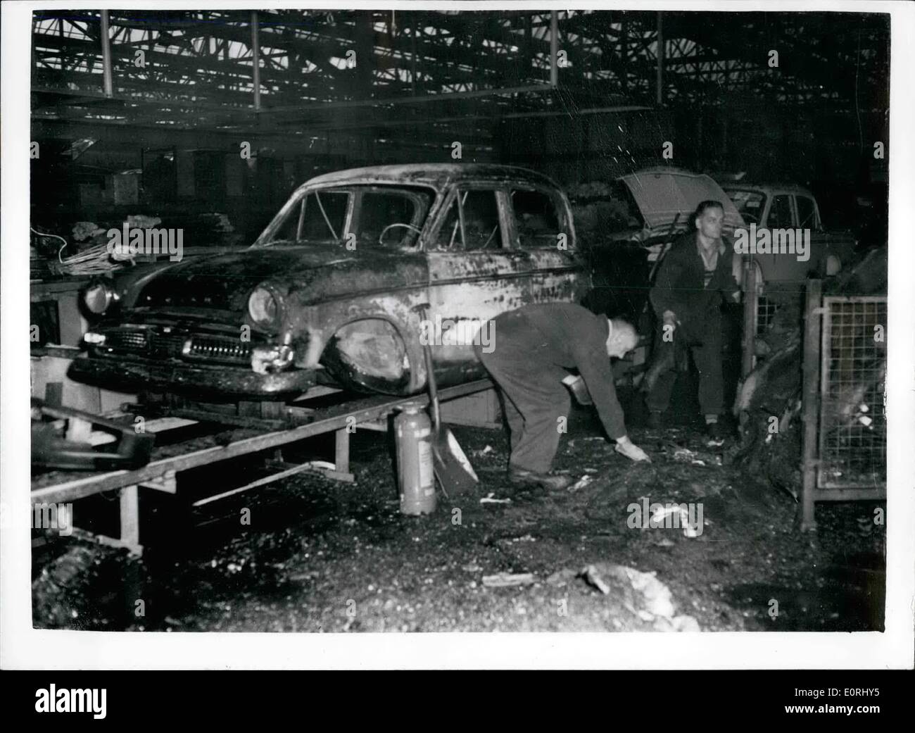Sep. 23, 1959 - 23-9-59 Fire causes heavy damage at Rootes Car Factory. Fire which broke out at the Rootes factory, near Coventry last night caused widespread damage. It took firemen three hours, pumping 100 gallons of water a minute, before the blaze was got under control. Warwickshire Fire Brigade said it was the biggest blaze they had ever had to tackle. Keystone Photo Shows: Damaged cars on the assembly line as clearing up progresses after the fire at the factory. Stock Photo