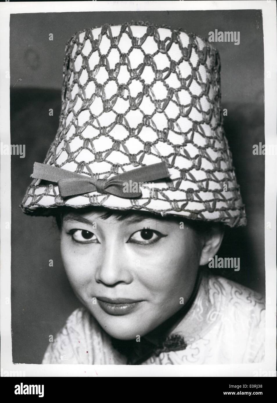 Nov. 11, 1959 - Hats on shown in London.: Photo shows Miss Tsai Chin, star of the new hit show ''The World of Suzie Wong'', wears this white straw hat, covered with lacquer blue net, shows the Eastern influence for Spring - designed by Dolores and shown in London today. Stock Photo