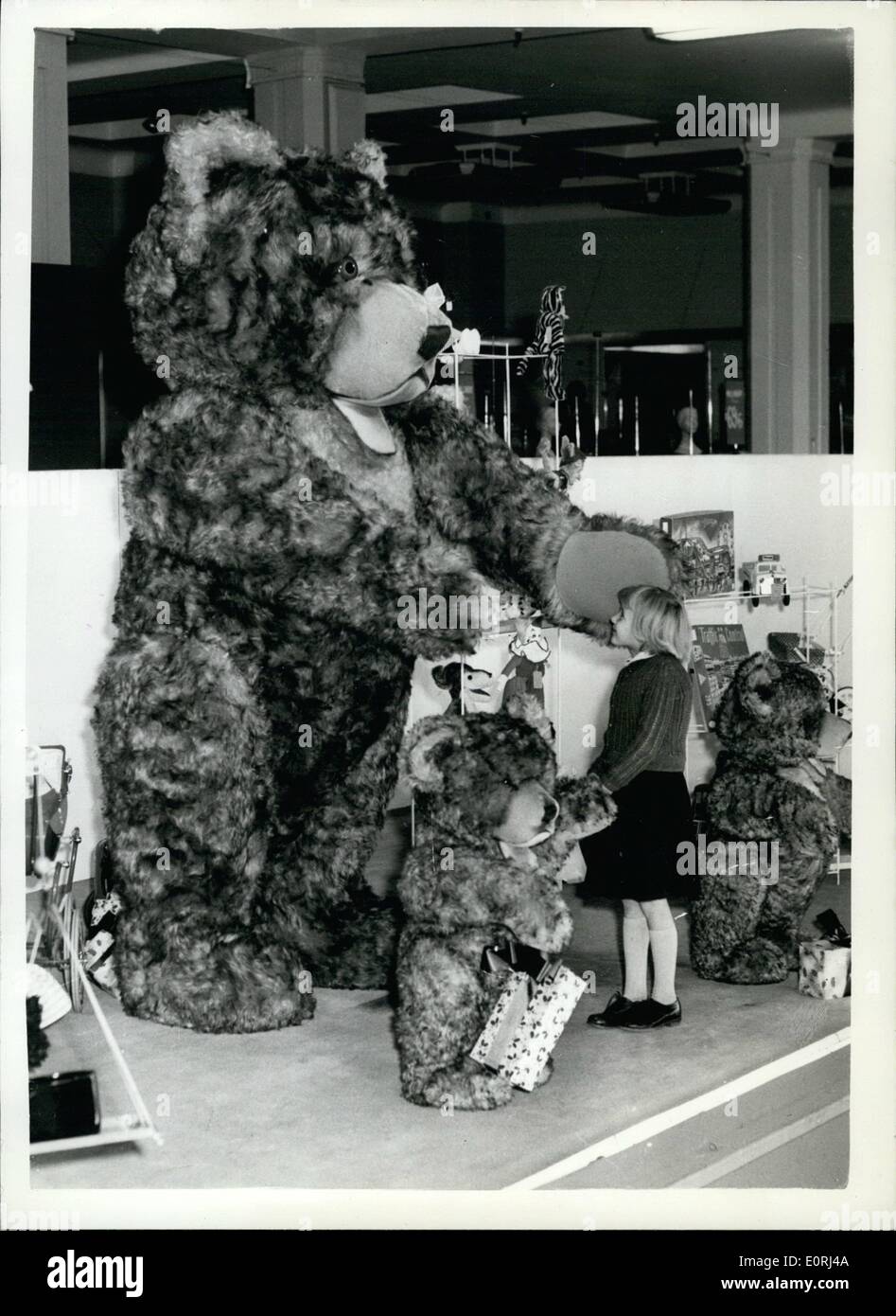 Nov. 11, 1959 - Janet And The Giant Teddy Hear: Little seven-years old Janet Bone, of Coulsdon, Surrey, seen almost warfare by this giant Teddy bear, which is now show at Bentall's store,. Kingston. Stock Photo