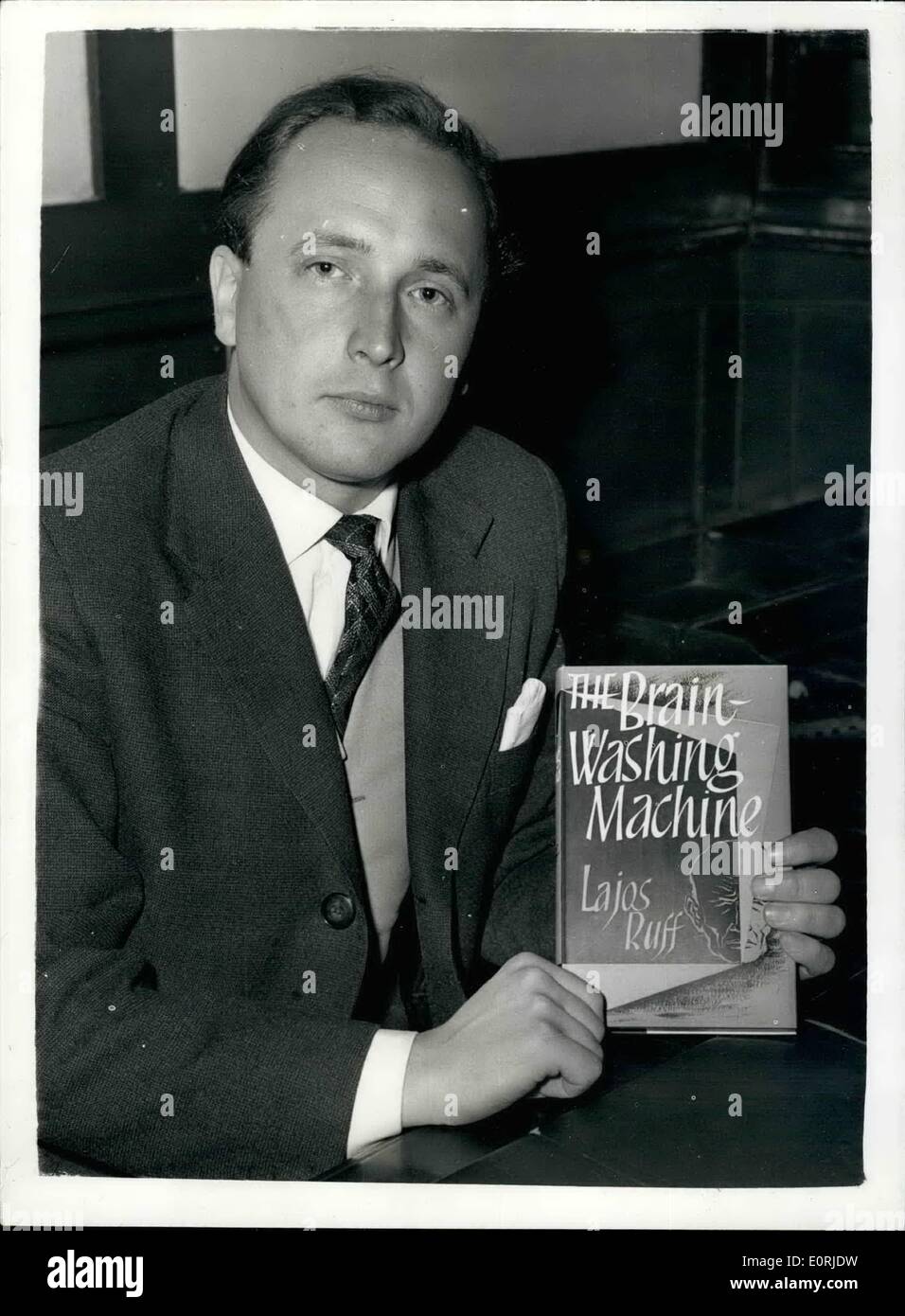Oct. 10, 1959 - AUTHOR WHO ESCAPED FROM HUNGARY - HOLDS PRESS CONFERENCE ON NEW BOOK ''THE BRAIN WASHING MACHINE'', LAJOS RUFF the young Hungarian author of the sensational soon .The Brain Washing Machine'' - held a press conference in London today. It is a story of the Communist brain-washing process by which the will of the victim is broken down,. The author is one of the very few to undergo this treatment - and to survive - sane.. KEYSTONE PHOTO SHOWS:- LAJOS RUFF with the book during the press conference today. Stock Photo