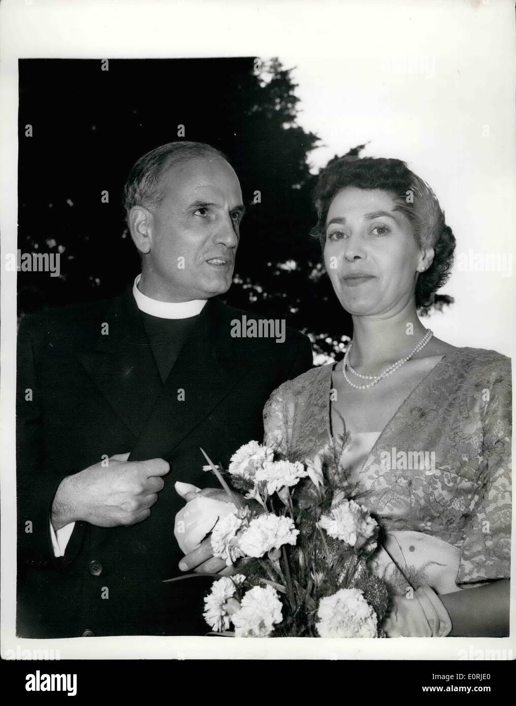 Oct. 10, 1959 - The Vicar weds a barmaid: Ex-barmaid Catherine Ling married the vicar yesterday at the village of Whitwell, in the Isle of wight. The Rev. John Elliott Roberts, 45-year-old former naval chaplain, met Catherine, aged 32, when she worked at a local hotel bar. The wedding was conducted by the vicar's brother, the Bishop of Mallmesbury, Wiltshire. Photo shows the Rev. John Elliot Roberts leaving the church with his bride, Catherine Ling, after their wedding yesterday. Stock Photo