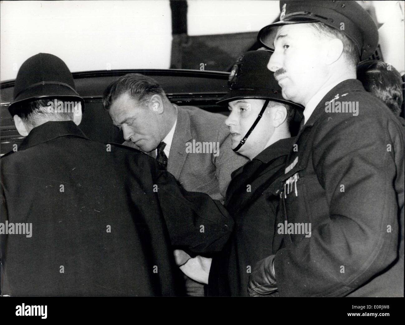 Dec. 12, 1959 - A Police Constable And Three Men Accused Of An 18,000 Bank Raid: 39-year-old Metropolitan Police-constable George Albert Askew was charged with three other men at Waltham Cross, Essex, yesterday of breaking into Chingford's National Provincial Bank and staling cash and jewellery worth 18,103. The men and two women - a mother and daughter were also accused of receiving part of the stolen money. All the accused were remanded for a week, the men in custody and the women on bail Stock Photo