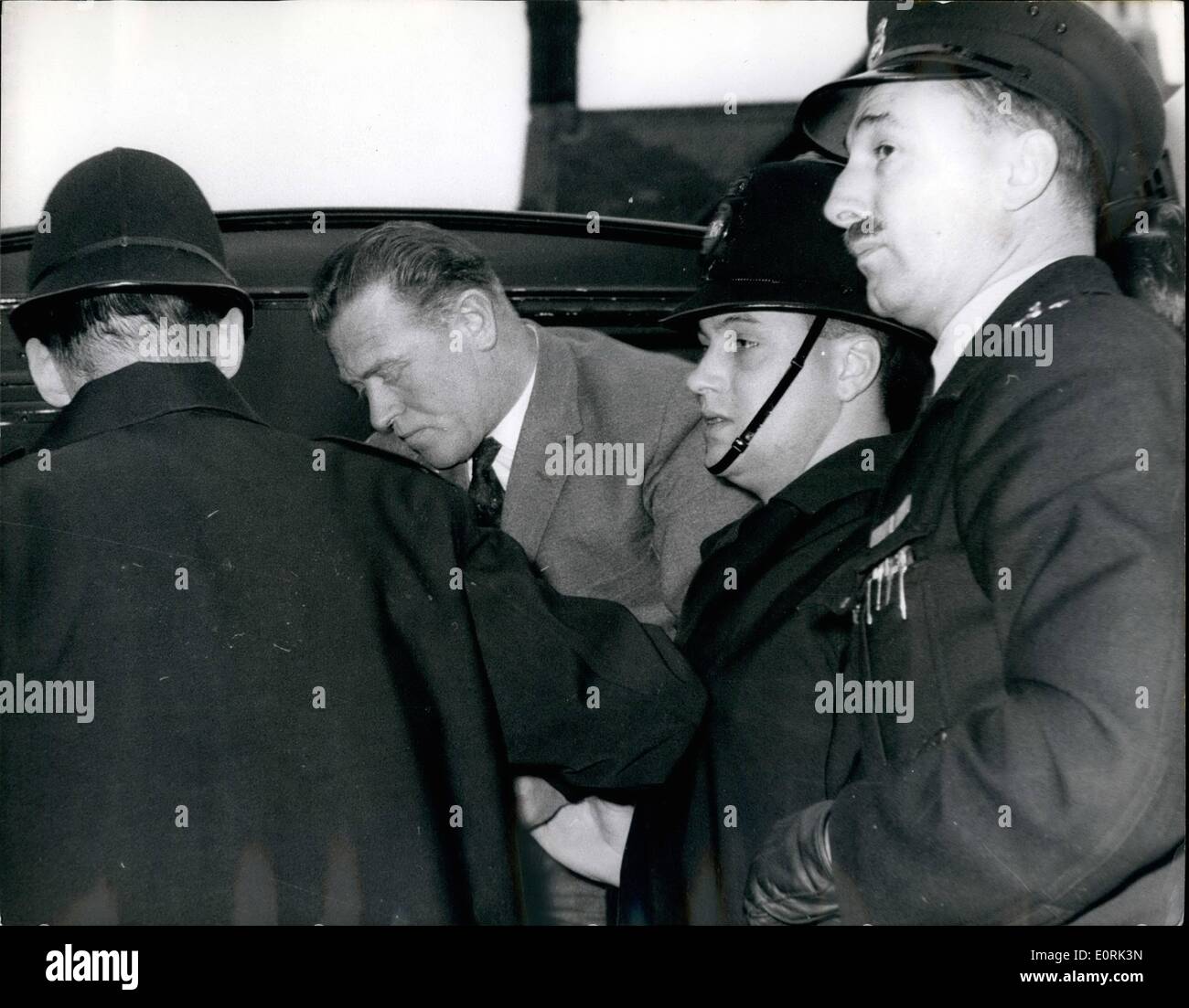 Dec. 12, 1959 - A Police Constable And Three Men Accused Of An 8,000 Bank Raid: 39-year-old Metropolitan Police Constable George Alberta Askew was charged with three other men at Waltham Cross Essex, yesterday of breaking into Chingford's National Provincial Bank and Stealing cash and Jewellery worth 8,103. The men and two women - a mother and daughter - were also accused of receiving part of the stolen money. All the accused were remanded for a week, the men in custody and the women on ball Stock Photo