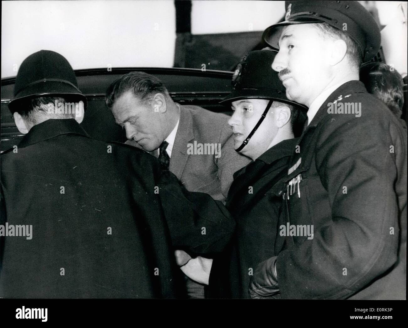 Dec. 12, 1959 - A Police Constable And Three Men Accused Of An 8,000 Bank Raid: 39-year-old Metropolitan Police Constable George Alberta Askew was charged with three other men at Waltham Cross Essex, yesterday of breaking into Chingford's National Provincial Bank and Stealing cash and Jewellery worth 8,103. The men and two women - a mother and daughter - were also accused of receiving part of the stolen money. All the accused were remanded for a week, the men in custody and the women on ball Stock Photo