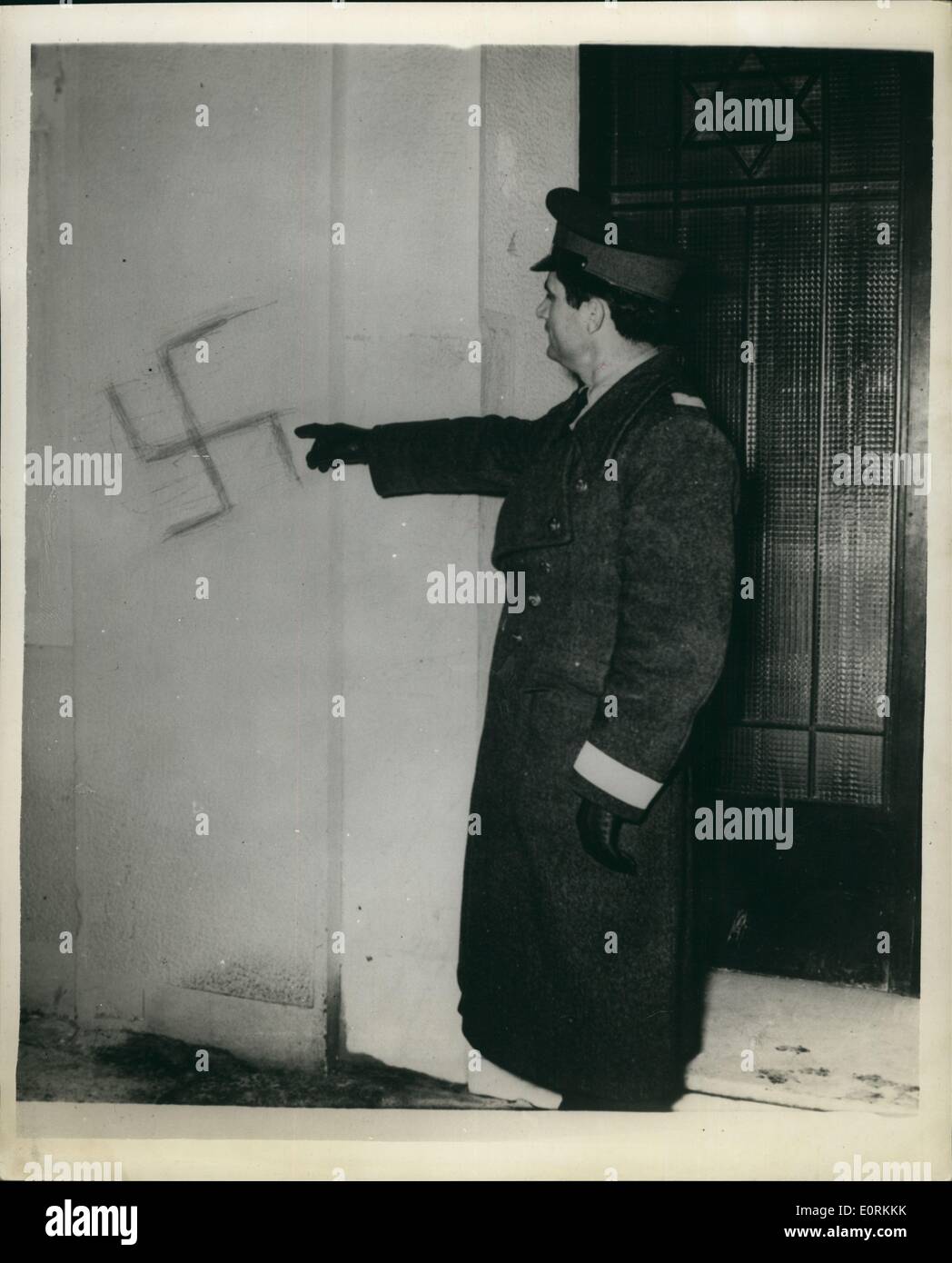 Jan. 01, 1960 - Swastikas on front of Jewish Synoagogue Athens Photo shows A policeman points to a stika which was painted on the walls of Jewish Synagogue in Athens on Monday night Stock Photo