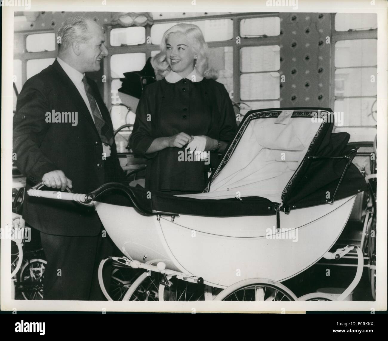Jan. 01, 1960 - Baby Buggie Shopper: Miss Diana Dors, British Star well-known in the state United States, names to Mr. Thomas A. Bent, Sales, Director of Marmet Ltd. her choice of a Queen baby Carriage in a London store. The wife of Mr. Dickie Dawson, a British comedian, Miss Dors expects there will be an addition to the acting profession next month. It will be her first. Stock Photo