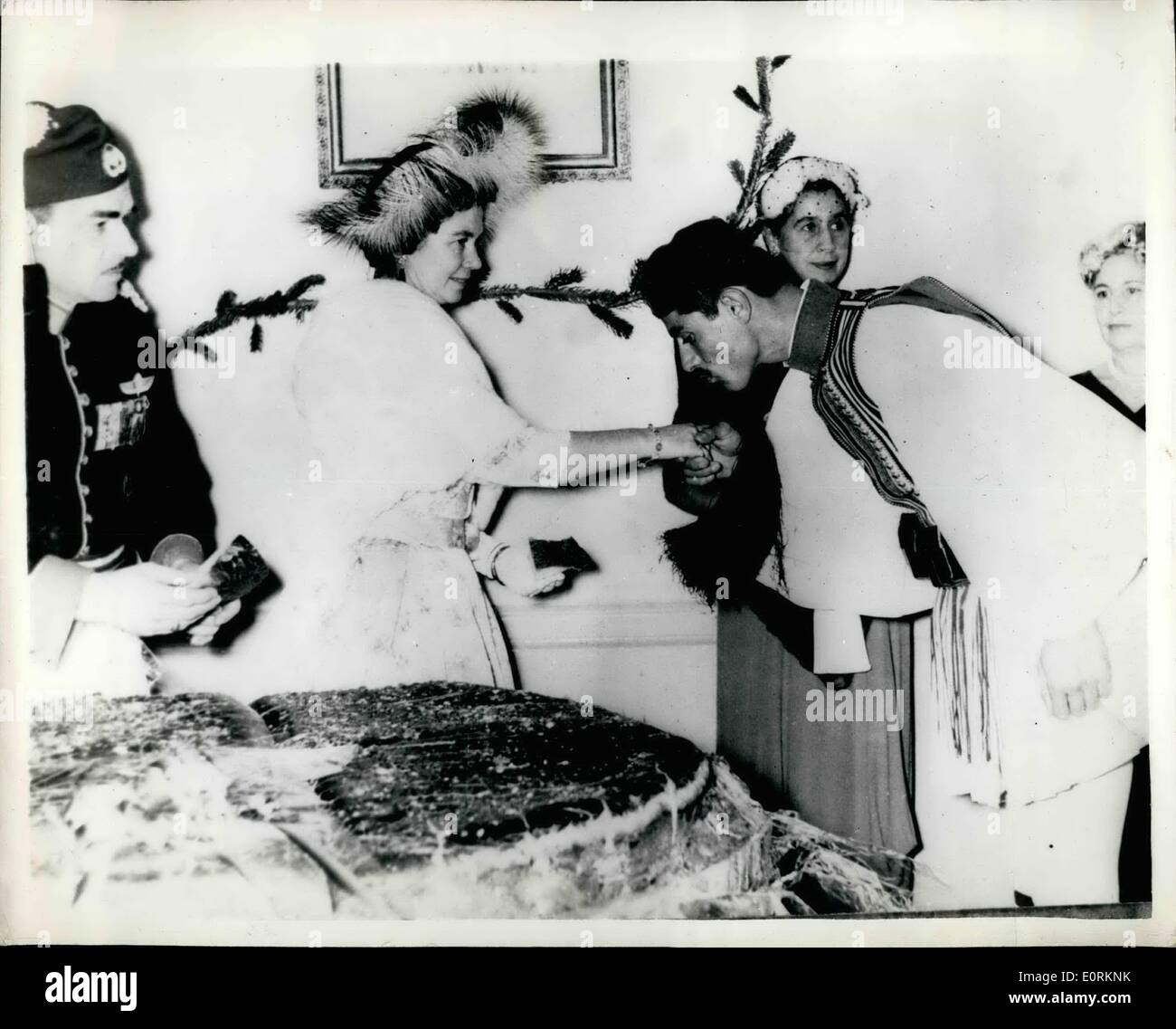Jan. 01, 1960 - New Year ceremony in Athens.. traditional cutting of the cake - by the Queen.. Queen Frederica of Greece performed the traditional ceremony of Cutting the New year cake - when with the King and other members of her family - she visited the royal guard - in Athens. Photo shows a member of the Royal Guard kissing the hand of the Queen - during the New year ceremonies in Athens. Stock Photo