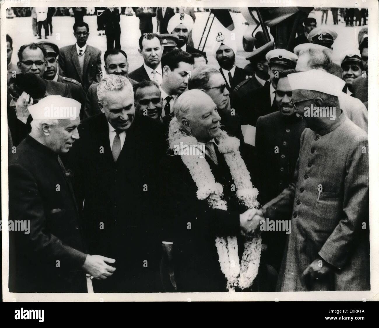 Jan. 01, 1960 - Mr. Voroshilov In India: President Rajendra Prasad, of India, on right, welcomes Soviet President. Mr. Voroshilov, seen garlanded, on the latter's arrival at Palam Airport, New Delhi on Wednesday, Jan. 20. On left, in white cap is Mr. Nehru, India's Prime Minister. Mr. Voroshilov, who is on a State visit to India, was today reported to be confined to his quarters with a temperature. Stock Photo