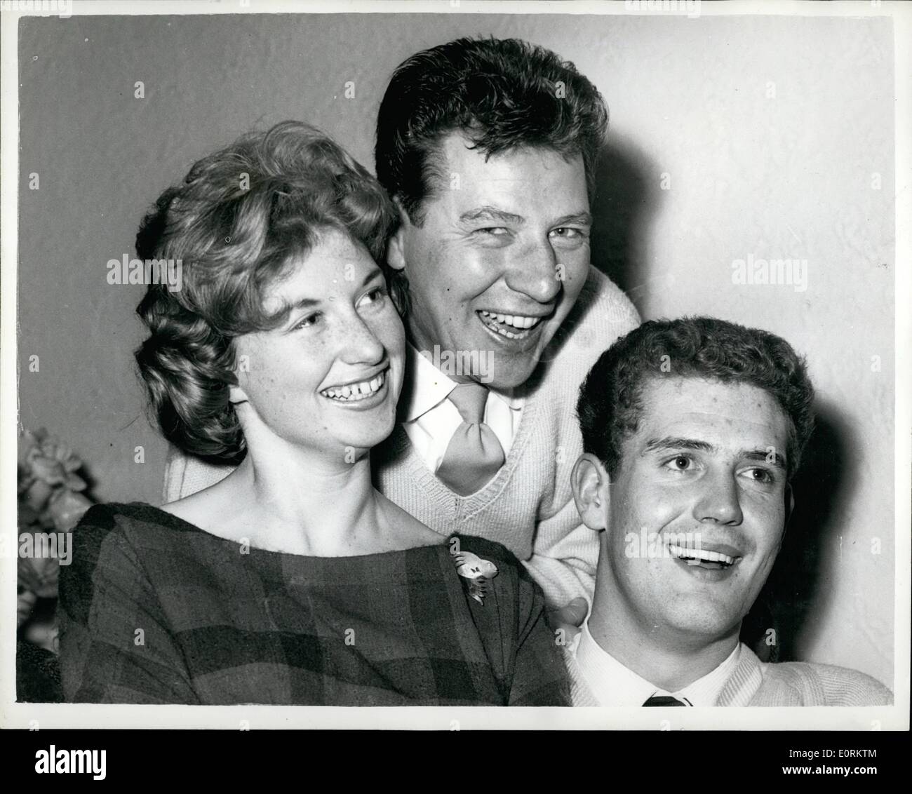 Jan. 01, 1960 - Max Bygraves' sixteen year old daughter gets engaged: Sixteen-year-old Christine Bygraves, eldest daughter of comedian Max Bygraves, and 20-year-old Richard Thomas, announced theri engagement yesterday. Christine, who will be 17 in May, has known Richard, who is training to be an accountant, for about four years. They plan to wed in 1962. Photo shows it's smiles all round from Max, daughter Christine and fiance Richard, after the announcement of the engagement yesterday. Stock Photo