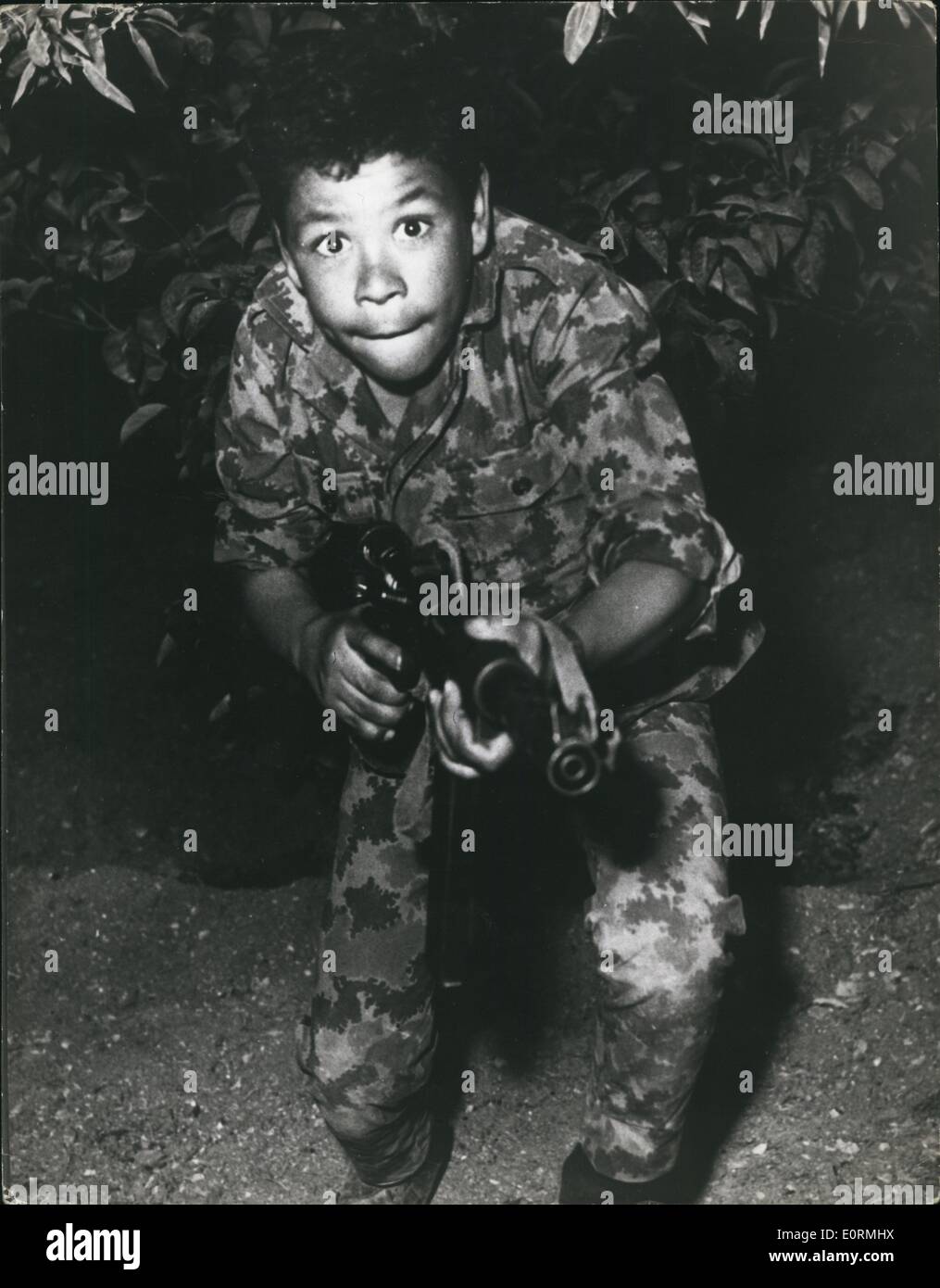 Jan 1, 1960 - 13 year old Kaled Abdul Rezak, with his machine gun, during assault training in the Jordan Valley : Stock Photo