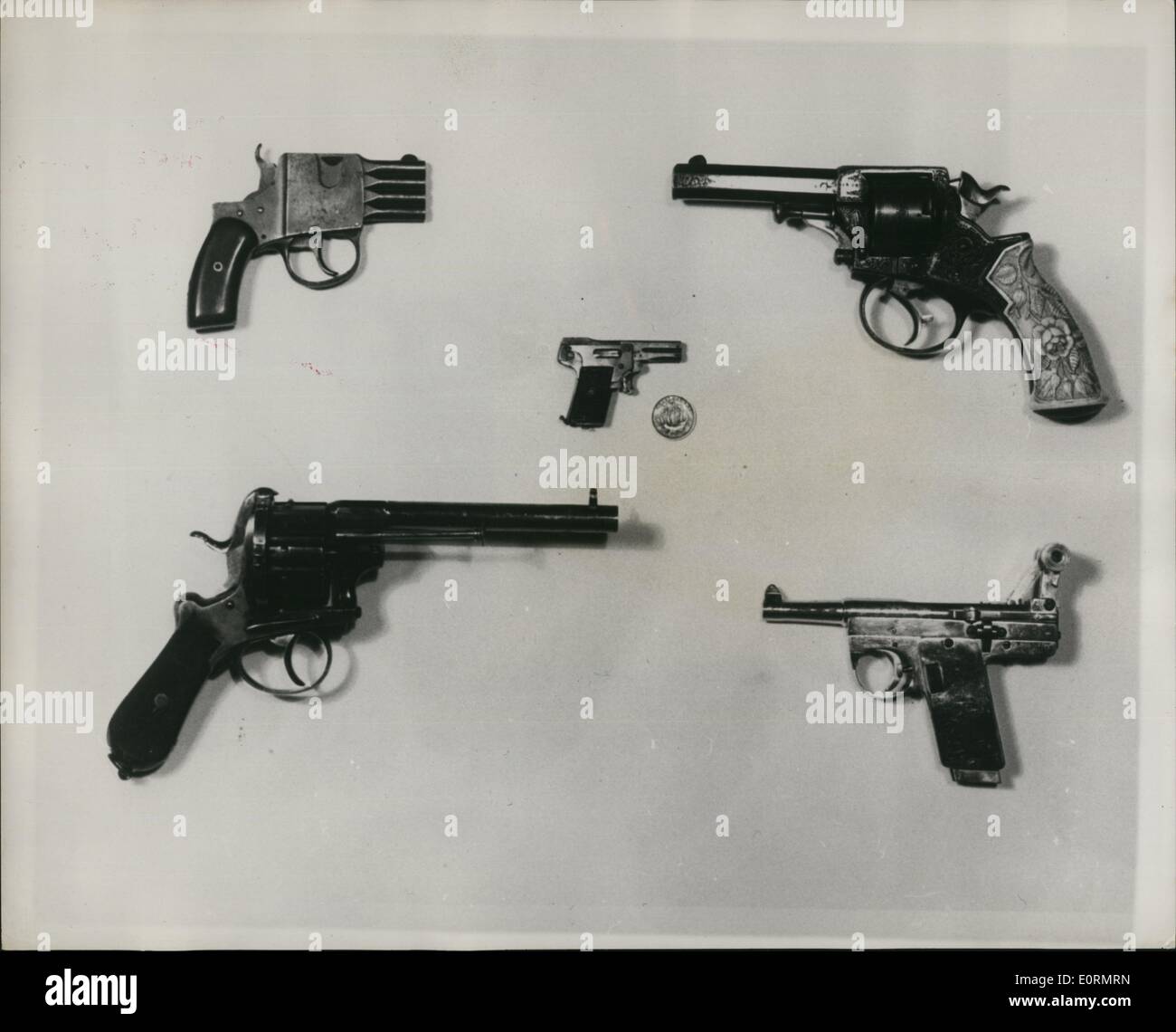 Jan 1, 1960 - Photo shows (Reading from left to right) Top. Bar Pistol (Regnum or Reform type). A common continental weapon; although appearing clumsy it is very flat and easy to conceal which probably accounted for its popularity. Tranter Revolver. A very fine specimen of a typical British ravolter of the late 19th and early 20th. centurtes. (Centre) : Kolibri Automatic Pistol. Smallest pistol of which the Museum is awar. A curiosity rather than a weapon, but still capable of being lethal. Shown with a halfpenny for scale Stock Photo