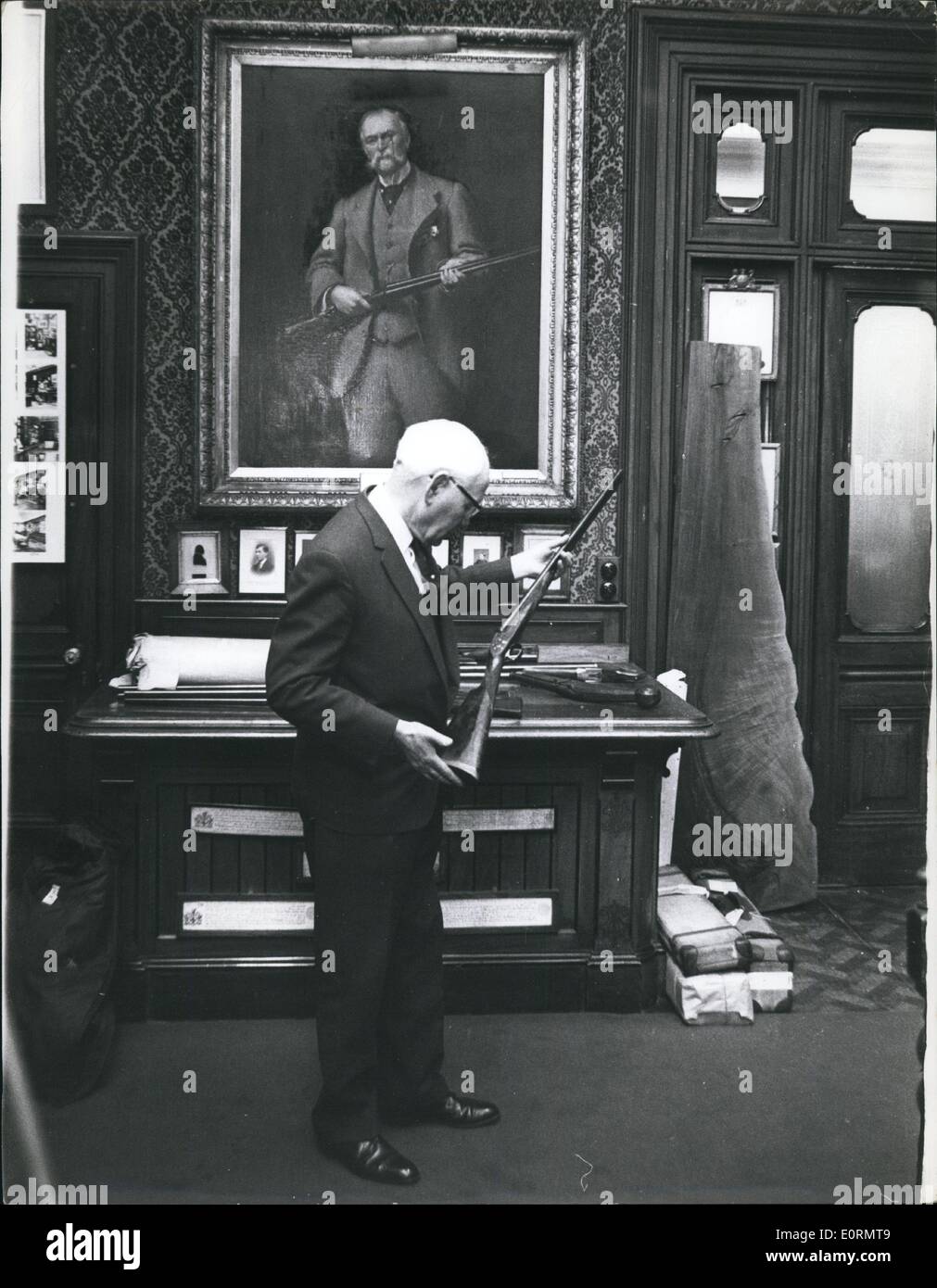 Jan 1, 1960 - Harry Lawrence balances a customer's gun in the famous Long Room at Purdeys - in the background is a portrait of Mr. James Purdy - founder of the business. Stock Photo