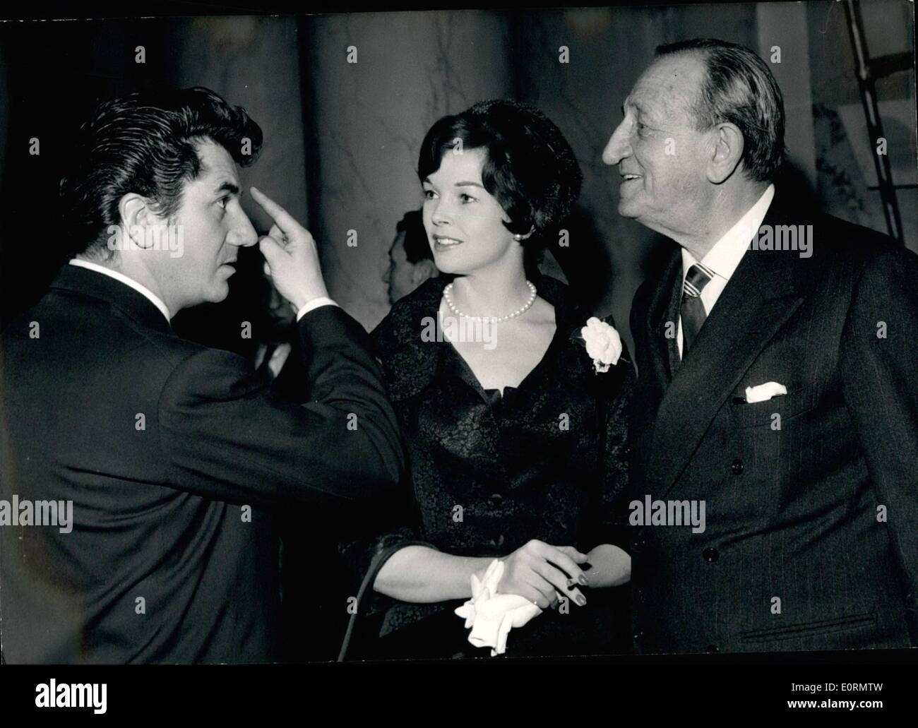 Mar. 03, 1960 - ''Don't I Look Like Nero? This is what Daniel Gelin, left, the famous French screen and stage actor, was heard to say to the Italian film director Carmine Gallone pointing to his ''Nero'' lock. The occasion was a cocktail party held by Gallone to celebrate the premier of his film ''Carthage en Flamme'' starring Daniel Gelin and Dawn Addams (center). Gallone is said to be planning a new film featuring Nero, the Roman Emperor. Stock Photo