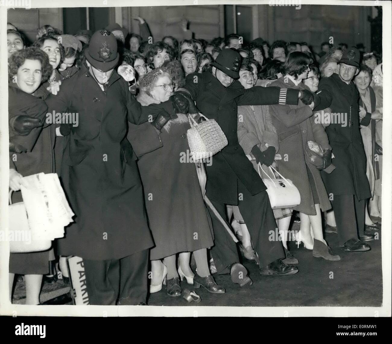 Mar. 03, 1960 - Princess Margaret and Husband-to-be and Queen Mother at Covent Garden.: Guests of honour this evening at the Royal Ballet Gars performance at Covent Garden - were the Queen Monther - Princess Margaret and her husband-to-be Tony Armstrong Jones. Photo shows police struggle to keep back the crowds awaiting the arrival of the Royal party this evening. Stock Photo