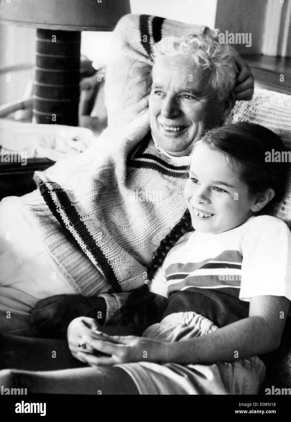 Actor Charlie Chaplin watching television with his daughter Geraldine Stock Photo