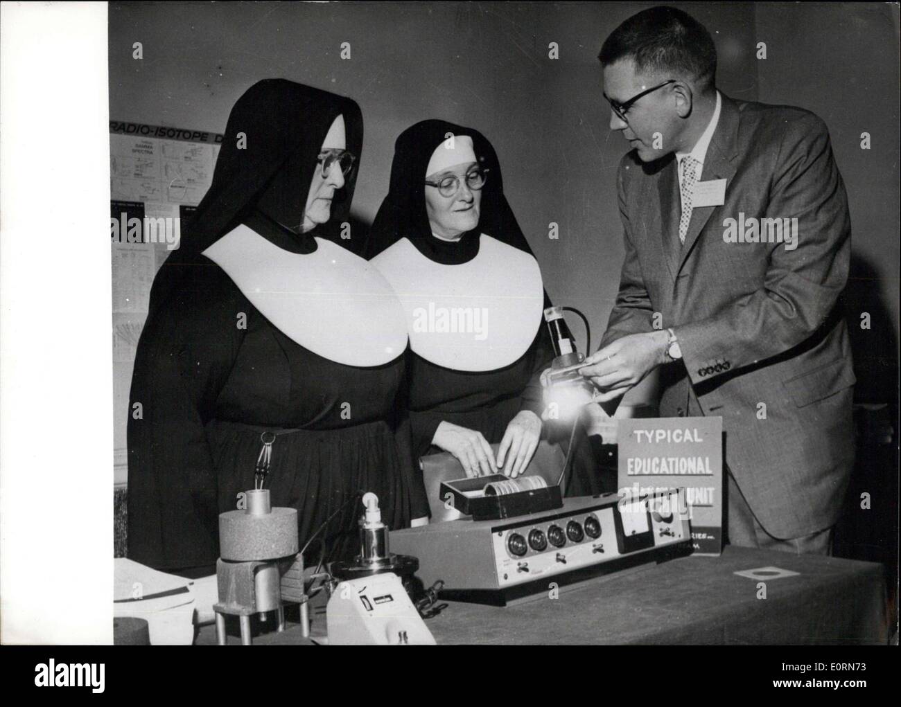 Jan. 19, 1960 - Typical atomic educational trainer unit: Dr. Davis R. Dewey 11, president of Baird-Atomic Inc., points out features of a typical educational trainer unit used in high schools and colleges to Sisters Mary Robert and John Nepomucene, physics professors of Trinity College, Washington. More than 500 scientists, educators and other persons attended the first symposium on nuclear education. Stock Photo