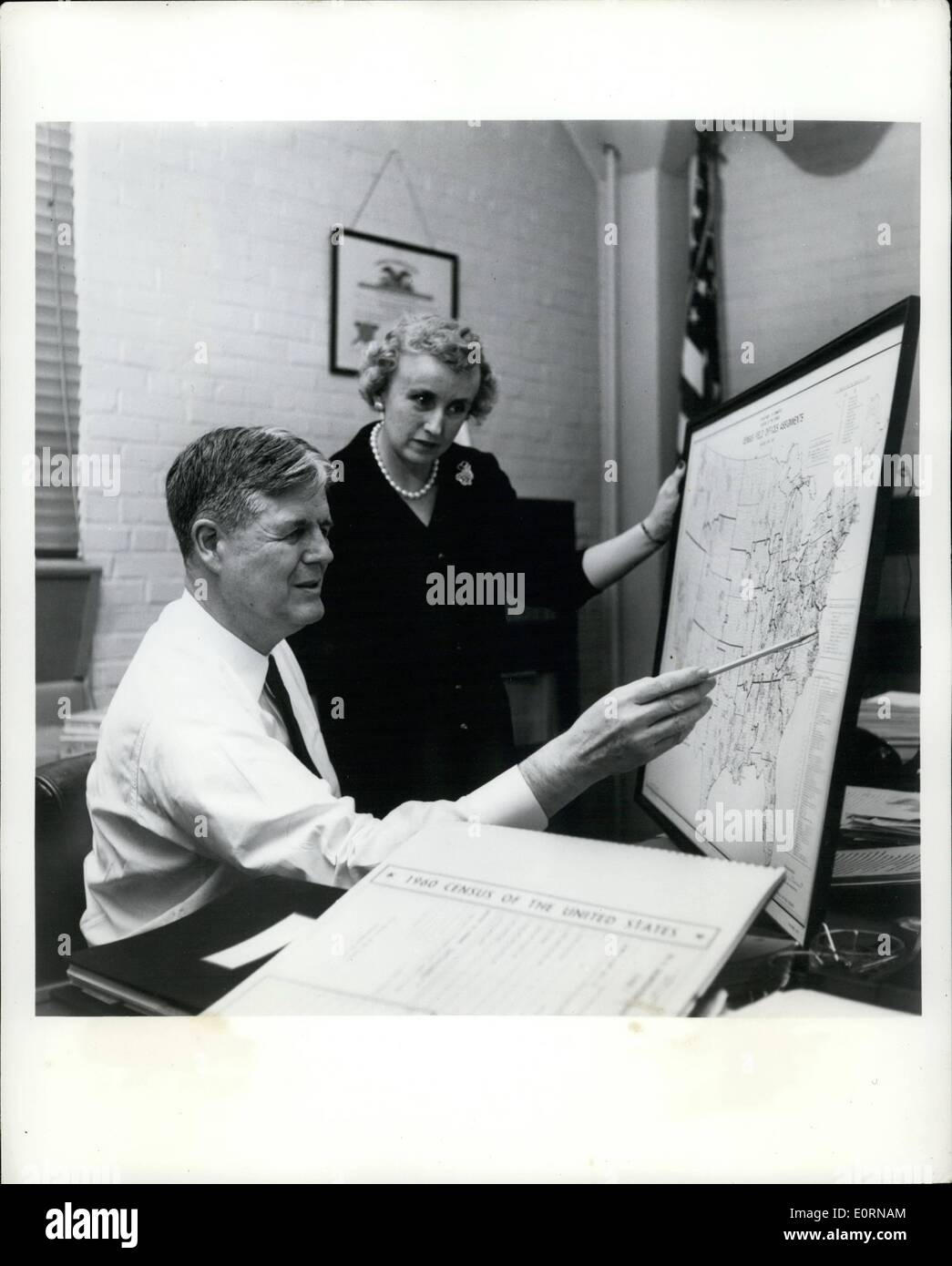 Mar. 03, 1960 - Picture Feature - The 1960 Federal Census Dr. Robert W. Burgess, Director of the Bureau of The Census, point out on a map of the United States, the different areas which will be covered by some 160,000 enumerators starting April 1. Miss Helen B. White, administrative officer to the Director looks on as they chart the assignments of the field offices through out the nation at the Census Bureau Headquarters in Suitland, Maryland. Stock Photo