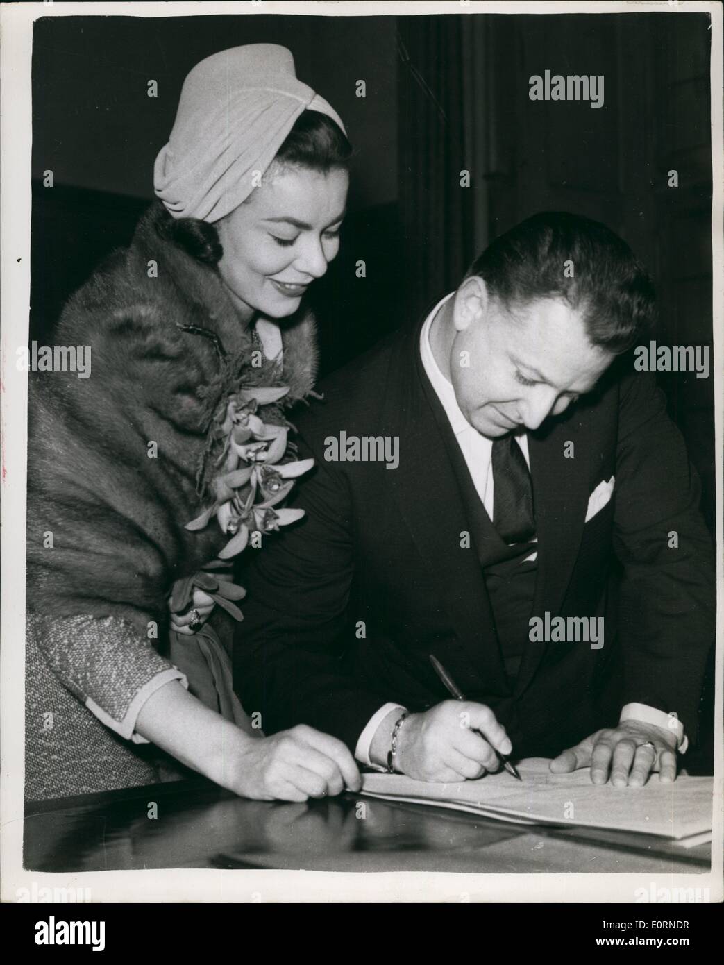 Feb. 02, 1960 - Screen Star Producer - In Zurich : Screen star Anne Heywood (28) and producer Raymond Stross (43) were married at the Town Hall in Zurich on Friday. Photo shows The Bride and Bridegroom sign the register - at their wedding on Saturday. Stock Photo