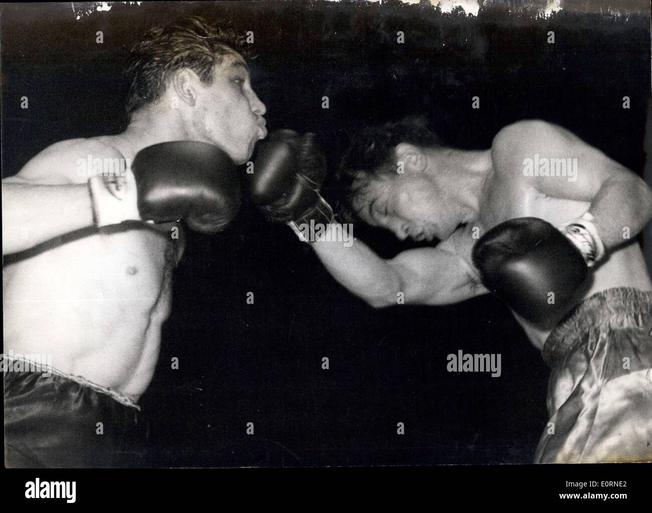 Feb. 02, 1960 - Wally Swift Becomes New British Welterweight Champion Wins On Points At Nottingham: Wally Switft of Nottingham last night won the British Welterweight Championship - when he beat reigning champion Tommy Molloy of Liverpool - on points over 15 rounds - at Nottingham. Photo Shows: Wally Swift (left) takes a crunching right hook to the chin - from Tommy Molloy during their fight.. Swift won on points. Stock Photo