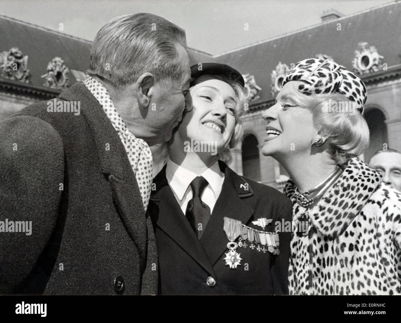 Mar. 12, 1960 - Paris, France - Dancer LYDIA LOVA former member of the French Resistance is congratulated by M. DORVAL and his wife after receiving her Legion of Honor. Stock Photo