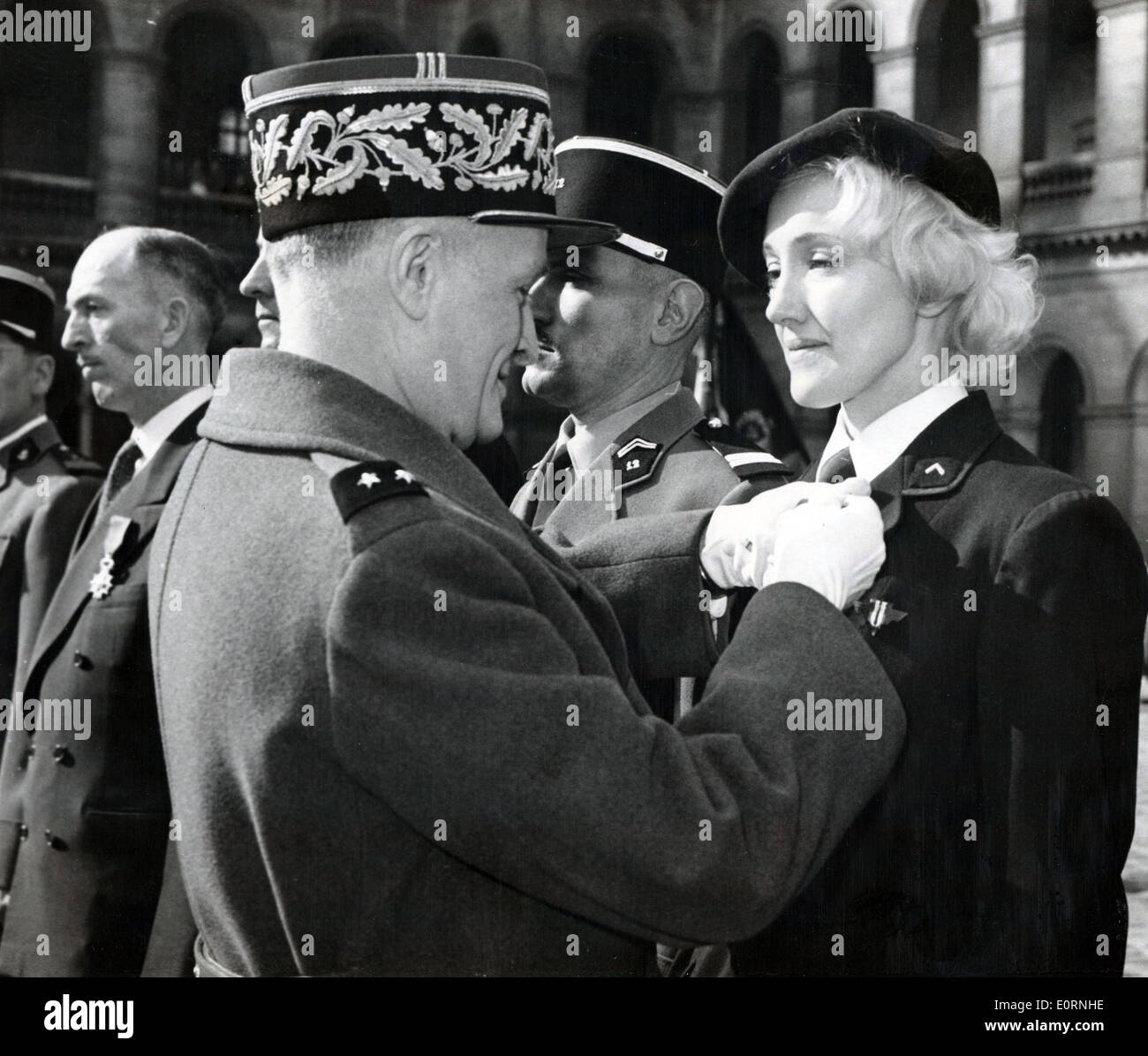 Mar. 12, 1960 - Paris, France - Dancer LYDIA LOVA former member of the French Resistance receives her Legion of Honor from General HENRI MASSOn during a ceremony held at the Invalides. Stock Photo