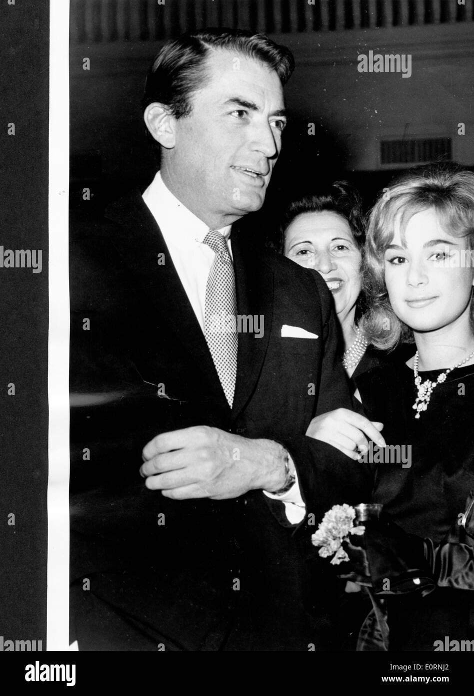 Actor Gregory Peck escorting Aliki Vougioklaki at the King's Palace Hotel Stock Photo