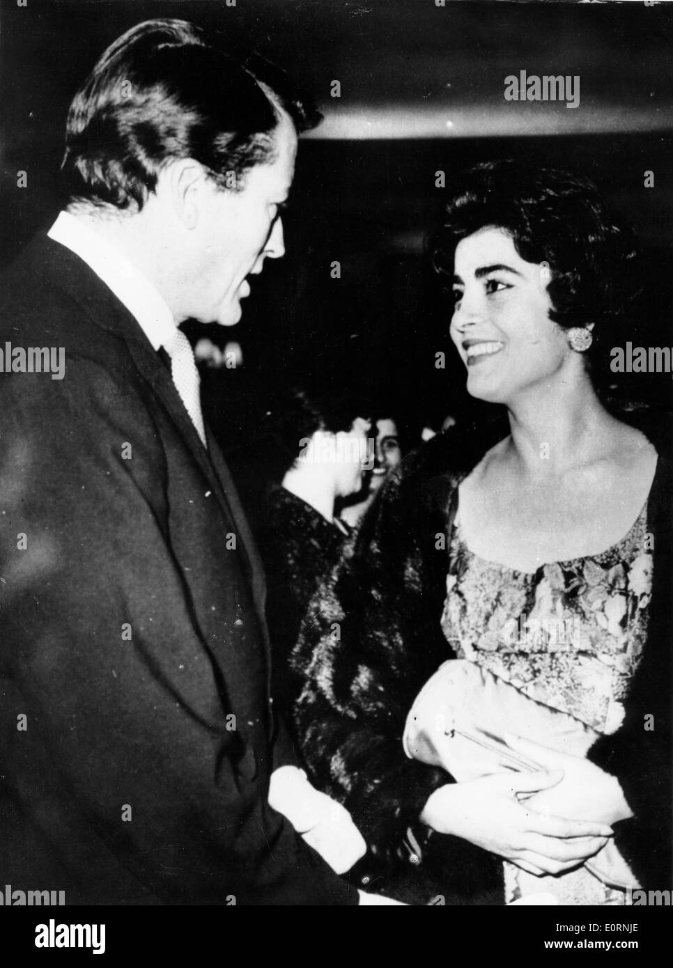 Actor Gregory Peck talking with Irene Papas at the King's Palace Hotel Stock Photo