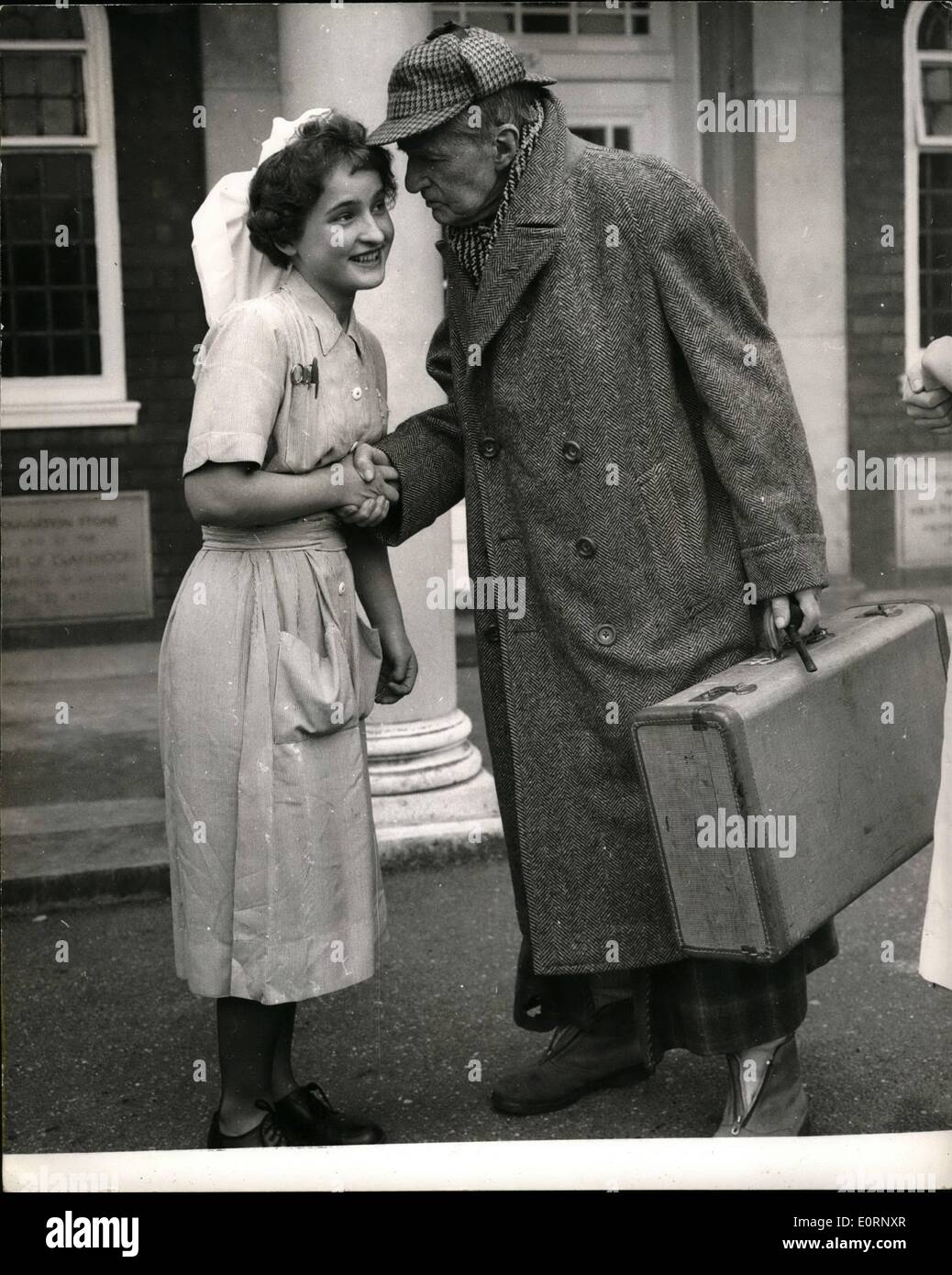 Feb. 02, 1960 - Matty Leaves Hospital: The 90-year old actor, A.E. Mathews left the Peace Memorial Hospital at Watford yesterday, where the spent four days recovering from a stroke. When he left he was wearing a deerstalker overcoat, dressing gown and show boots. Photo Shows A nurse says goodbye to A.E.Mathews, when he left the hospital yesterday. Stock Photo