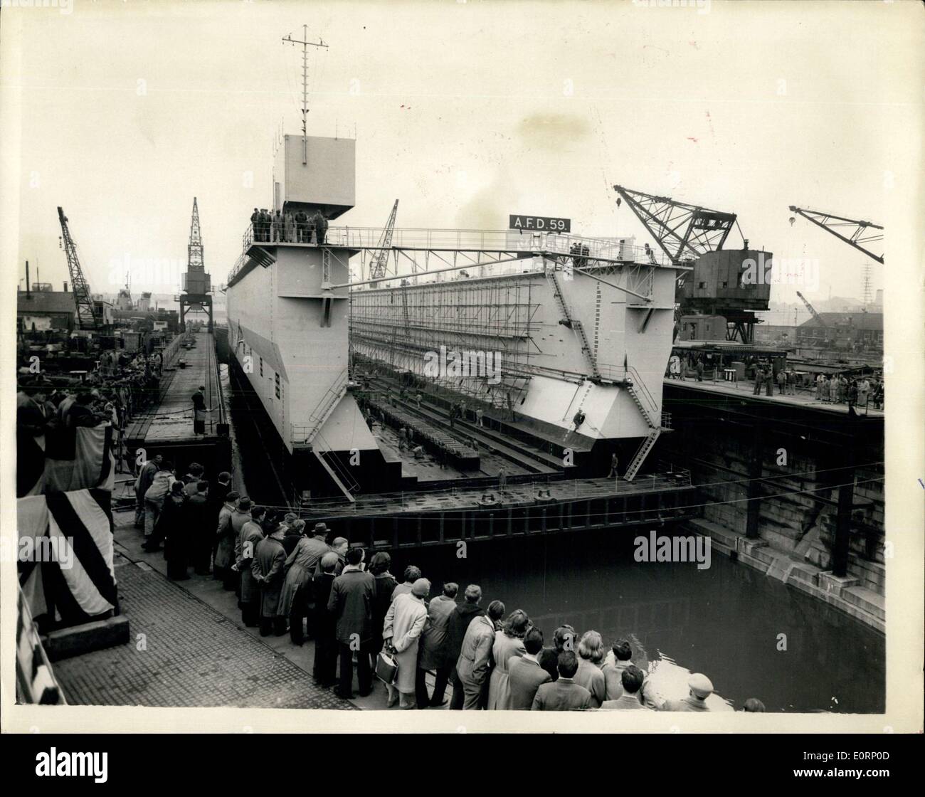 Mar. 31, 1960 - ''Launching'' Of New Admiralty Dock: Lady Carrington, wife of the First Lord of the Admiralty, today performed the ceremony which started the ''flooding-up and ''launching'' of the Royal Navy's latest floating dock at H.M. Dockyard, Portsmouth. The dock was laid down in January last year and will be used in the fitting out of H.M.S. Dreadnought, the first British nuclear submarine, which is being built at Barrow-in-Furness Stock Photo