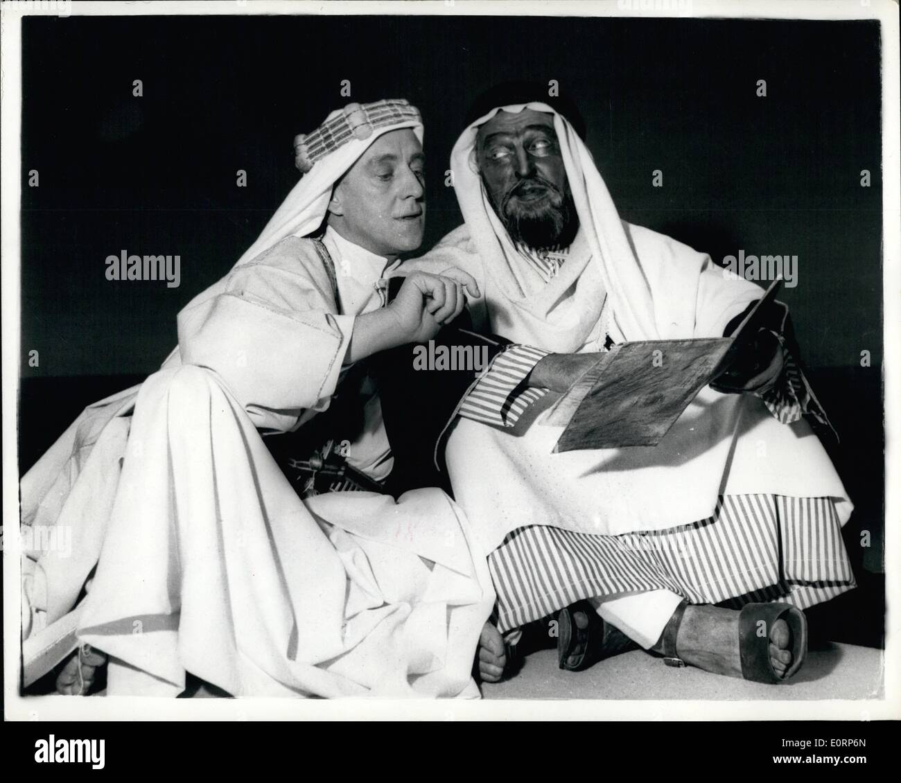 Apr. 04, 1960 - Sir Alec Guinness Plays ''Lawrence Of Arabia'': Sir Alec Guinness is presenting the role of Lawrence Of Arabia -- in the play ''Ross'' -- now at the Royal Court Theater, Liverpool....The play is by Terence Rattigan.. Photo Shows Sir Alec Guinness as Lawrence talking of Mark Digman who is Auda -- in the premiere of the play at the Royal Court, Liverpool. Stock Photo