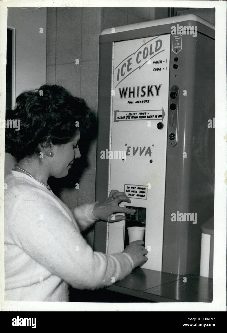 Feb. 02, 1960 - Automatic Vending Exhibition Opens.. Whisky-And-Soda - From Slot Machine.. The Second Automatic Vending Exhibition and Convention opened at the Royal Horticulture Hall, Westminster. Keystone Photo Shows:- Monica Bays helps herself to a whisky and soda - from the automatic drink dispensing machine - produced by Rollason Aerocessaries of Croydon. This machine automatically mixes whisky - soda; whisky water - to required proportions by insertion of 2/6d.. The machine is equipped with time switches which looks it - automatically to conform with licensing hours. Stock Photo