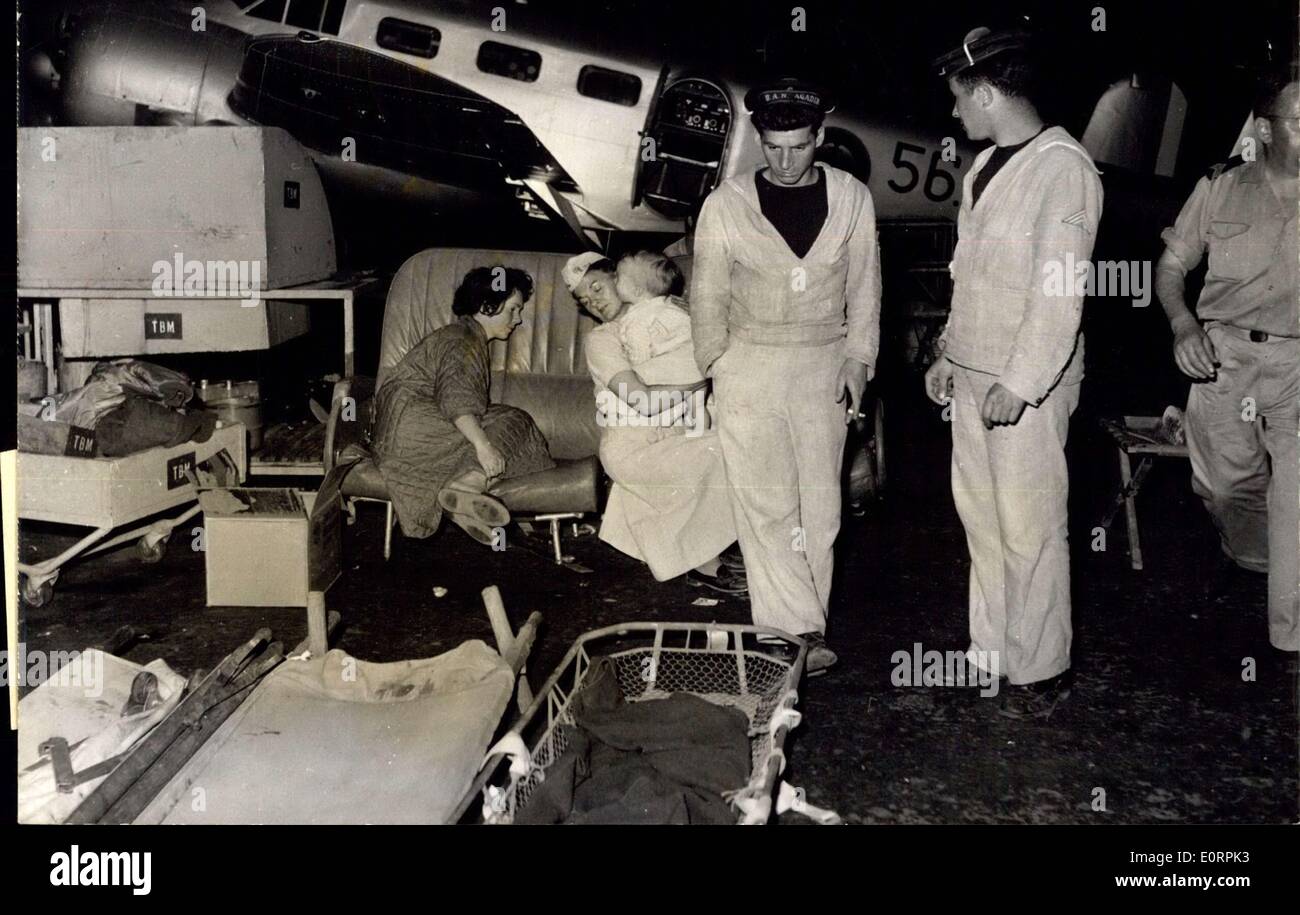 Mar. 02, 1960 - AGADIR EARTHQUAKE. OPS: STRETCHERS LINING THE HANGAR OF THE AGADIR BASE WITH SAILORS ATTENDING TO THE INJURED. IN THE BACKGROUND A NURSE HOLDING IN HER ARMS A CRYING BABY. Stock Photo