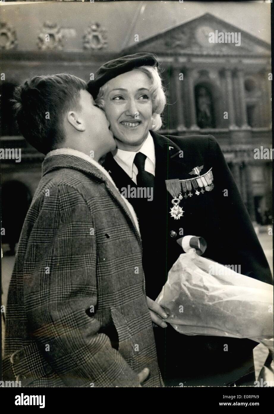 Mar. 03, 1960 - Folies Bergere dancer former member of French resistance decorated; Lydia Lova (Alias mme Kotczak Lipski), a Folie bergere dancer, former member of the French resistance was awarded the Legion D'Honneu for her activity during the German occupation. Photo Shows Ten year old Patrick kisses his heroic mother, Lydia Lova after she was awarded the insignia of the legion D'Honneur during a ceremony held at the invalides this morning. Stock Photo