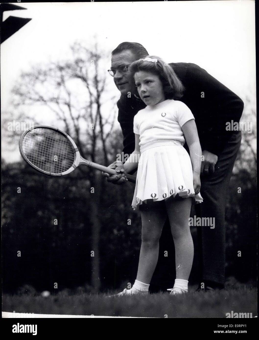 May 03, 1960 - Expert tuition for Five-year old Helen.: Jaroslav Drobny, the former tennis star, pictured giving instruction to Stock Photo
