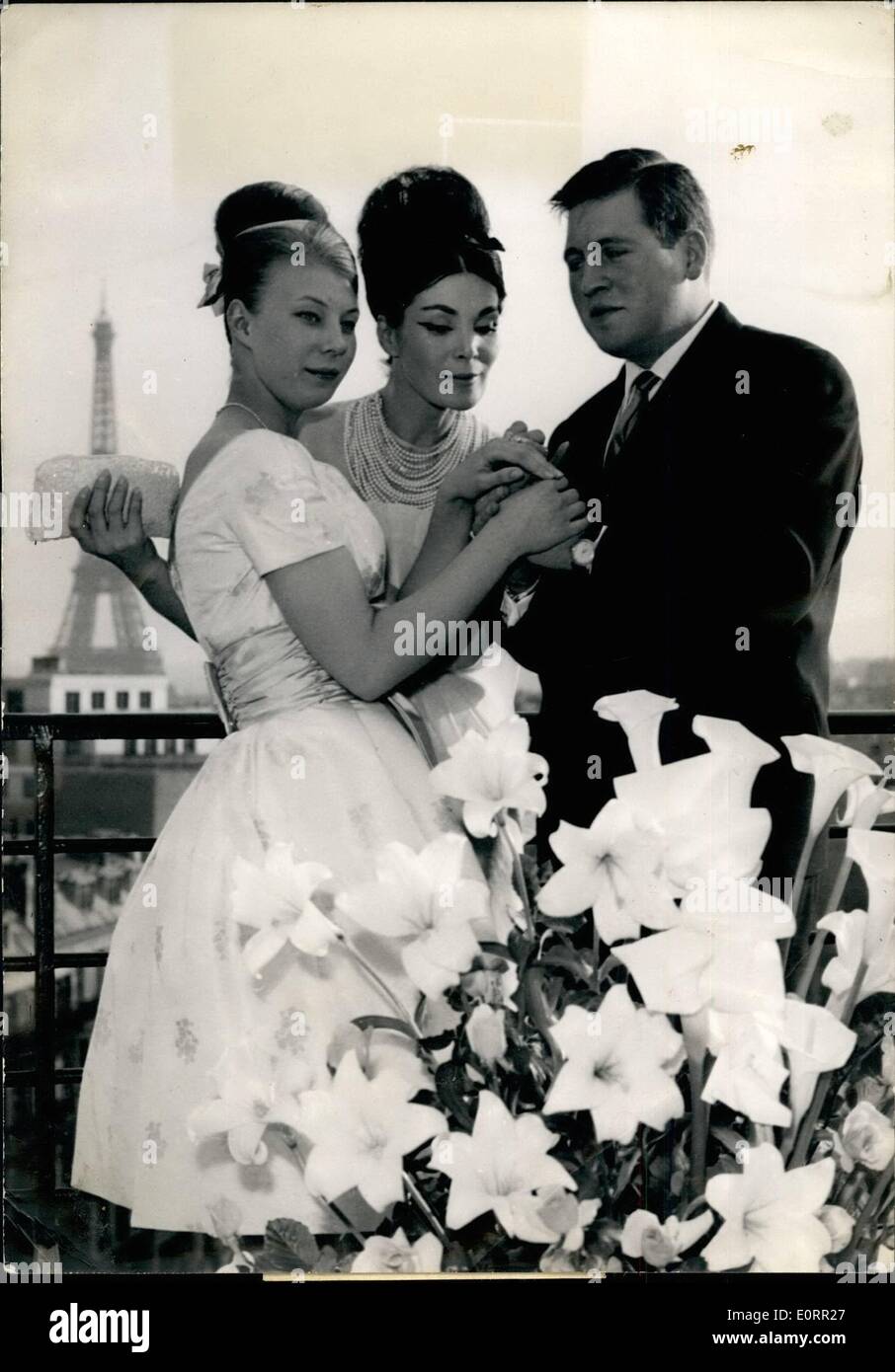 May 05, 1960 - Lucky's daughter to wed: Eighteen-year old Michele, Lucky's daughter, will marry Jean Louis Solminac, 26 who runs with his father a big transport en company. Lucky, one of the leading and best known French Haute Couture Mannequin announced her daughter's engagement to-day. Lucky (center) pictured with her daughter Michele and Michele's fiance Jean Louis Solminac. Stock Photo