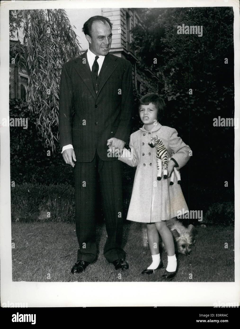 May 05, 1960 - Prince Aly Khan and Daughter Yasmin: Photo shows Prince Aly Khan, pictured with his little Daughter yasmin, in the garden of his house in Neuilly, paris yesterday. Stock Photo