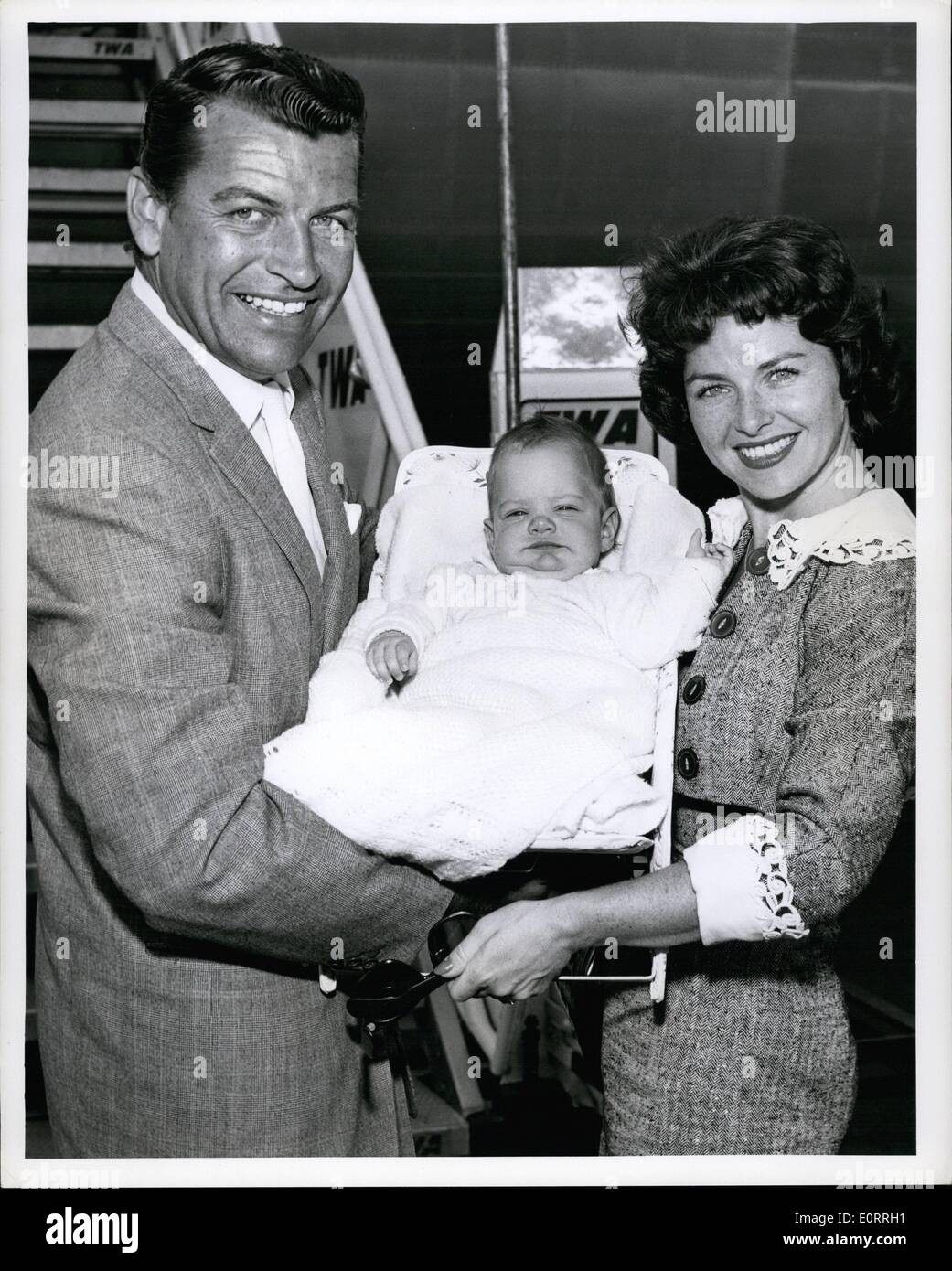 May 05, 1960 - N. Y. International Airport, May 31, 1960: Movie actor Richard Egan and his wife, the former Pat Hardy of N. Y. C. are pictured with their four month old daughter Patricia Narie on their arrival via TWA superjet from Los Angeles. On June 3 he will be leaving for Rome to star in his next picture ''Esther and the King' Stock Photo