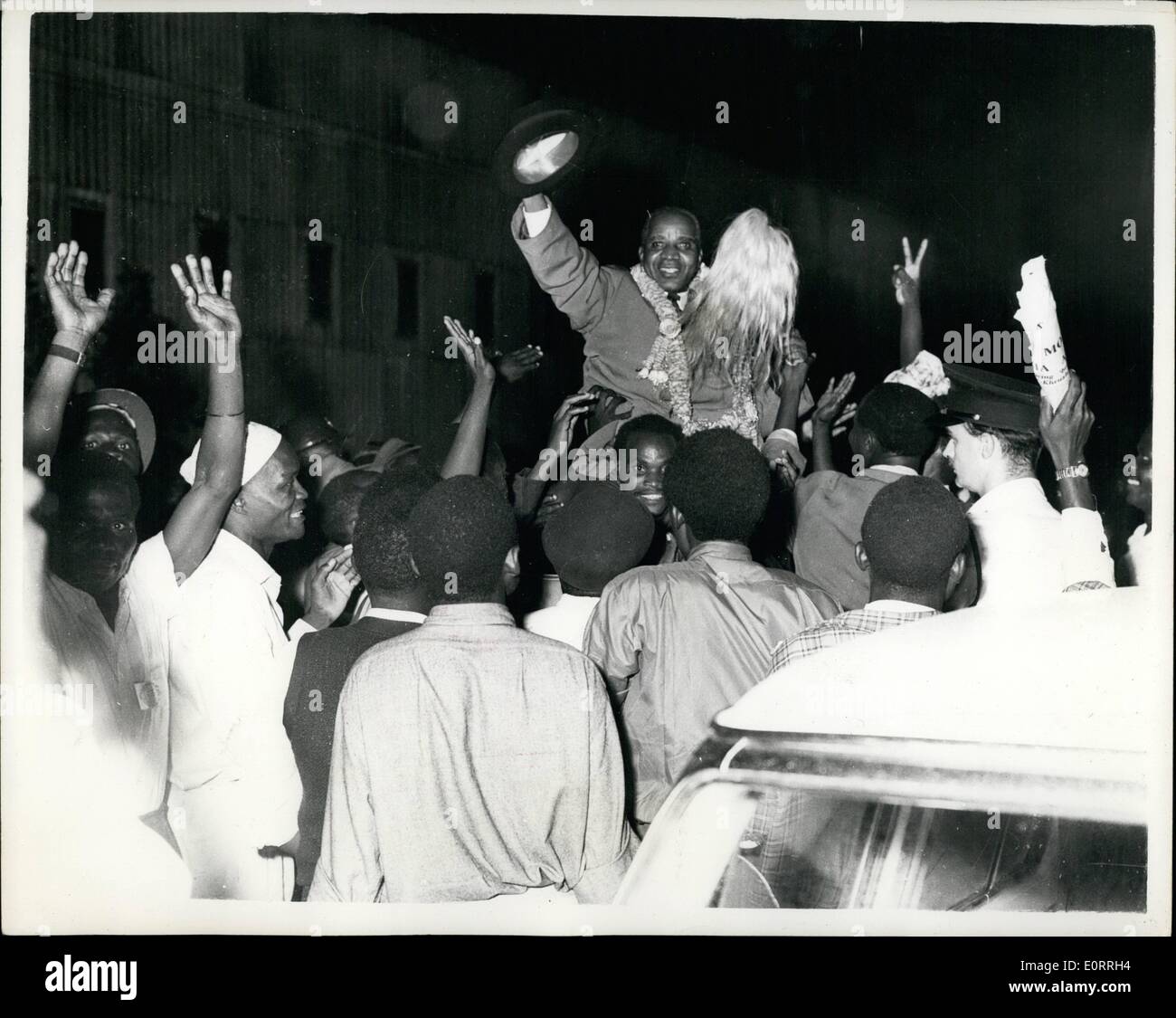 May 05, 1960 - Dr. Hasting Banda gets a great welcome on arrival in Mombasa: Dr. Hastings Banda the Nyassaland Leader gets a rousing reception from Lenya African Nationalists at the part of Mombasa... He waves a tribal fly-whisk at the crowd - while wearing a garland which was placed on his Nairobi. Stock Photo